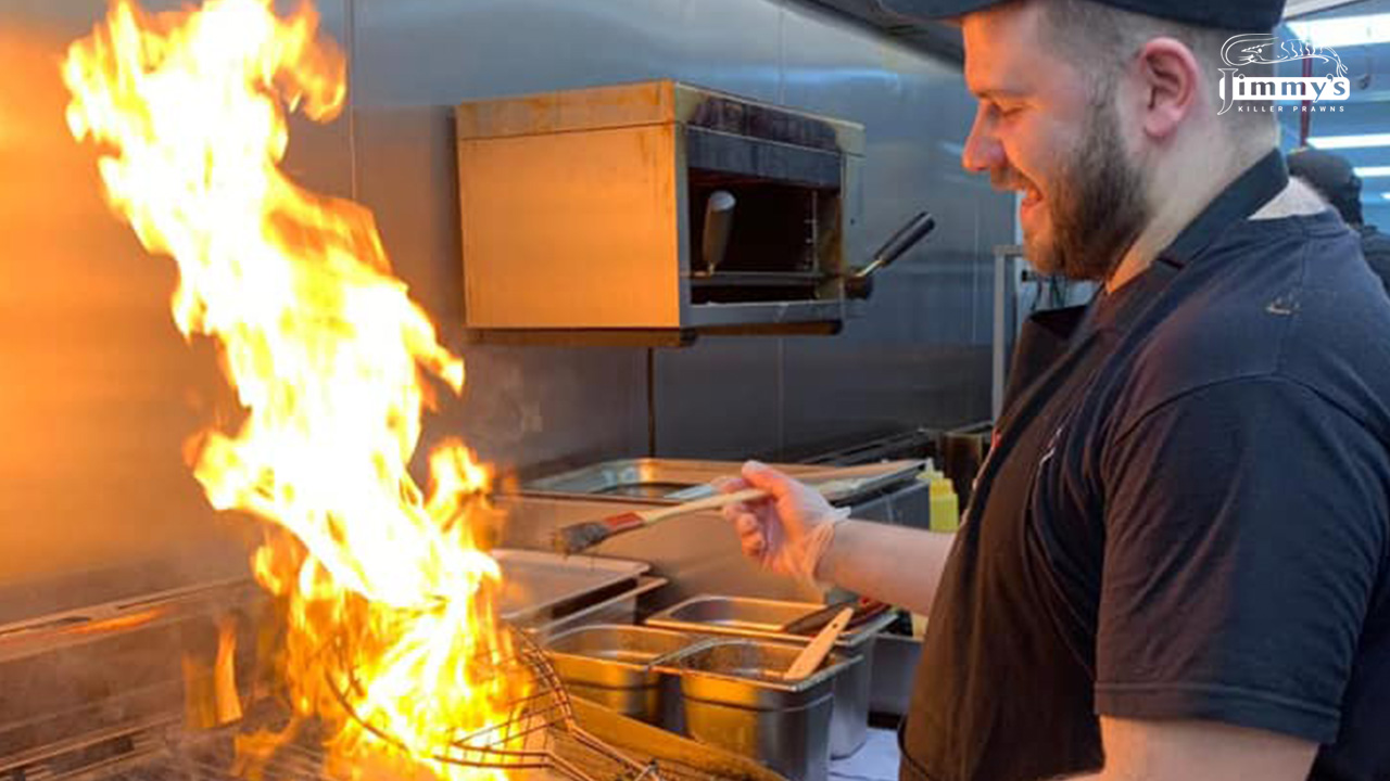 Chef cooking with flames in the open kitchen