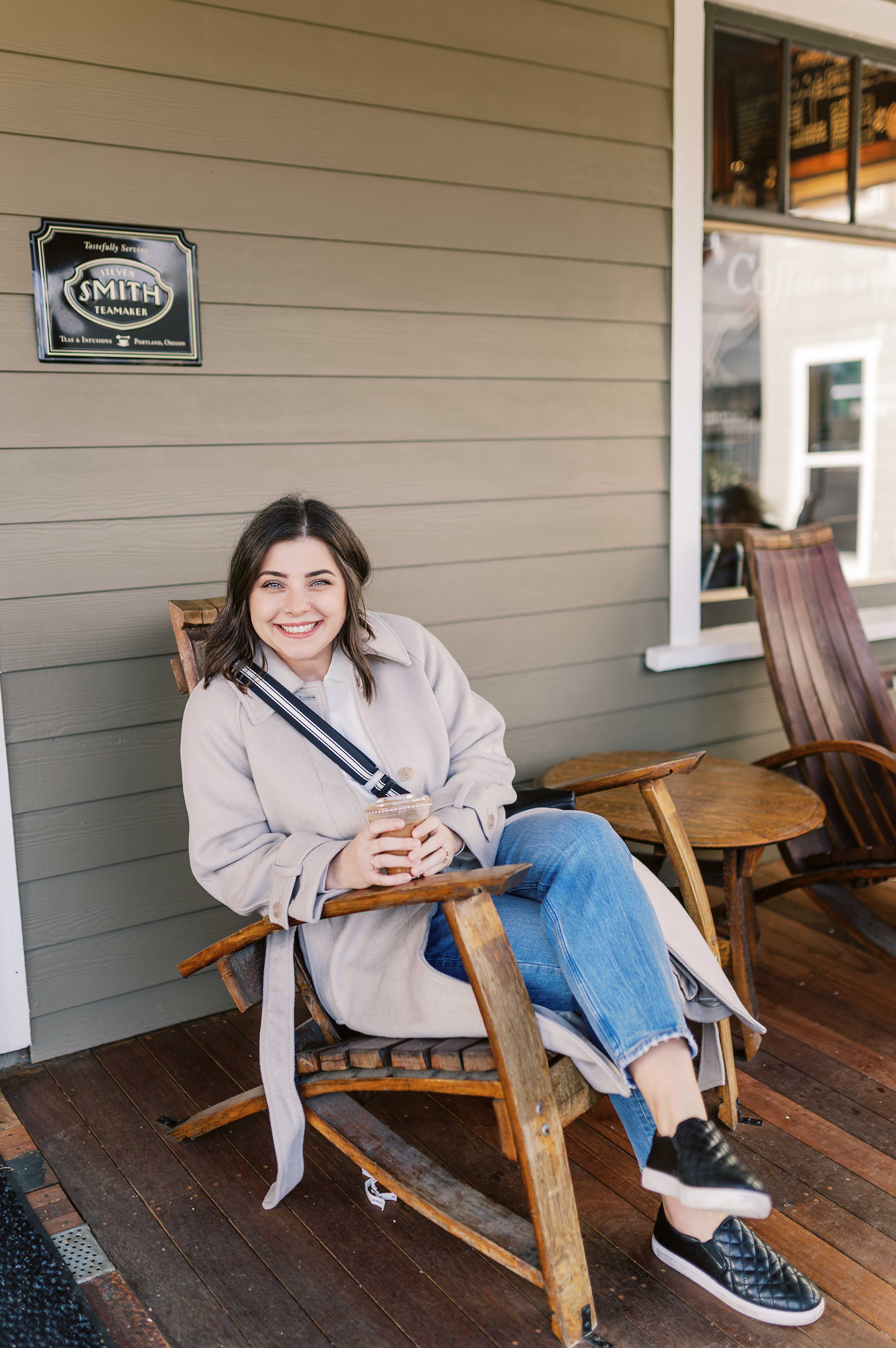 Jordyn sitting outside Smith Teamaker with an iced coffee