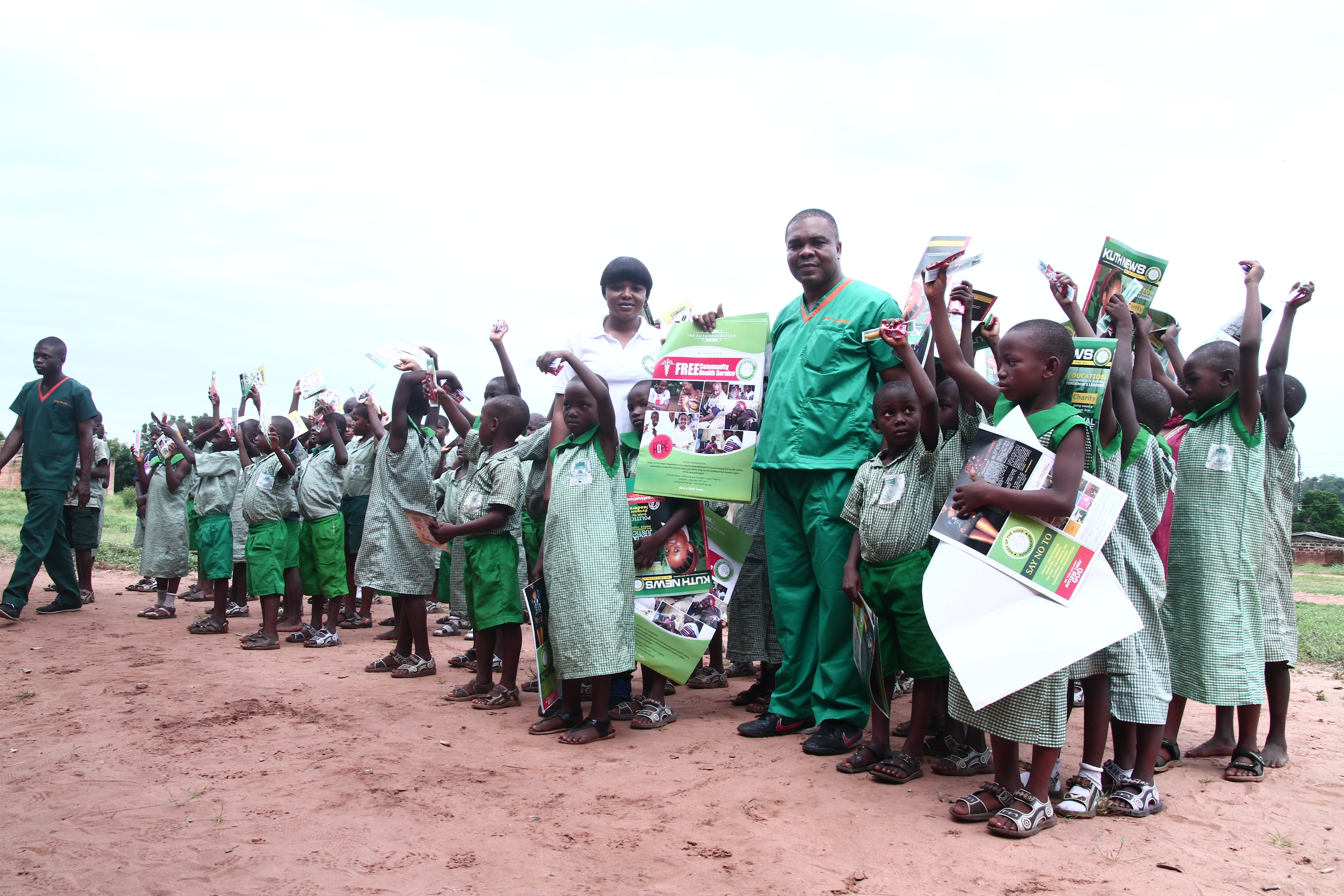 Team distributing KUTH publications to school children