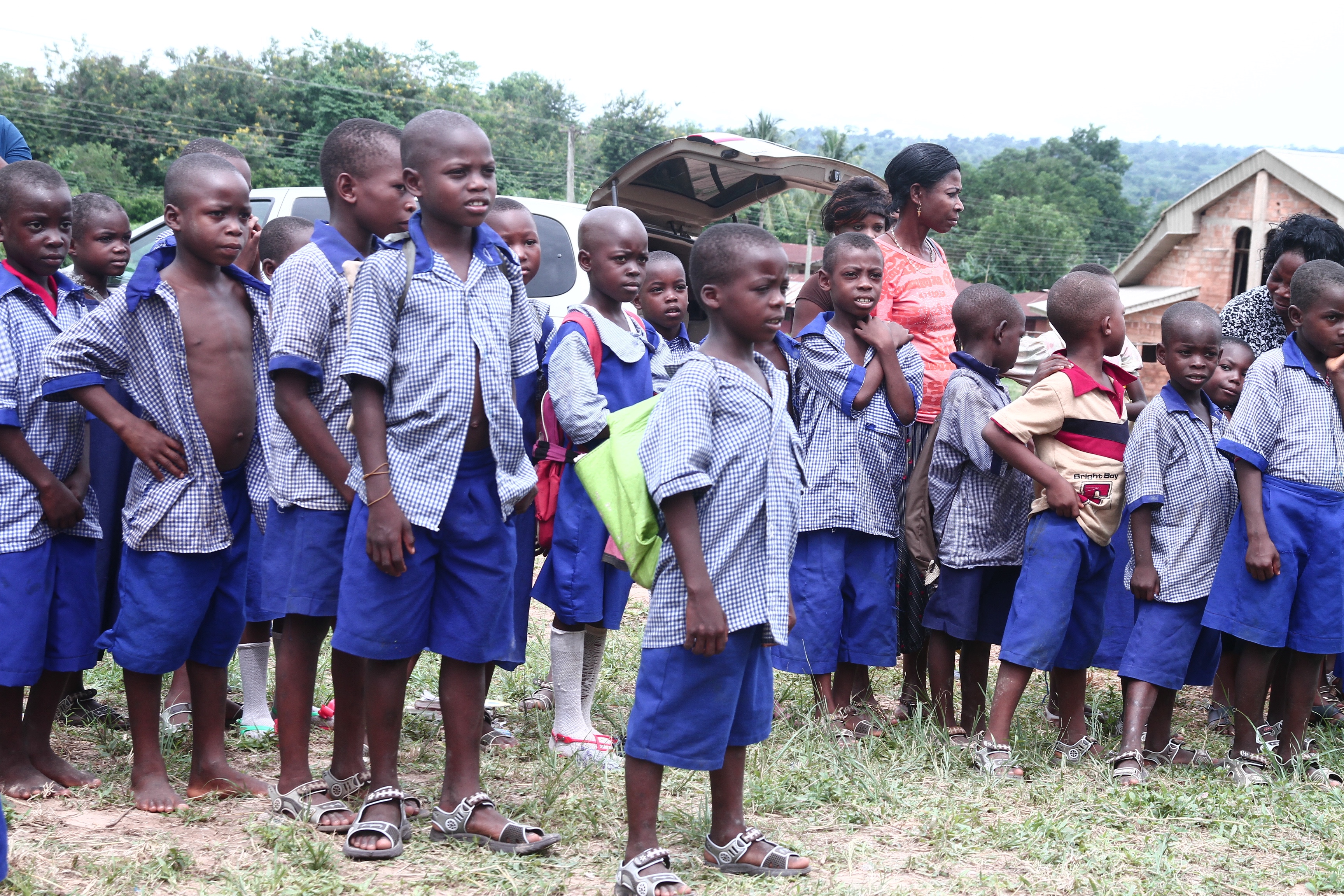 Pupils in blue uniforms lined up at school