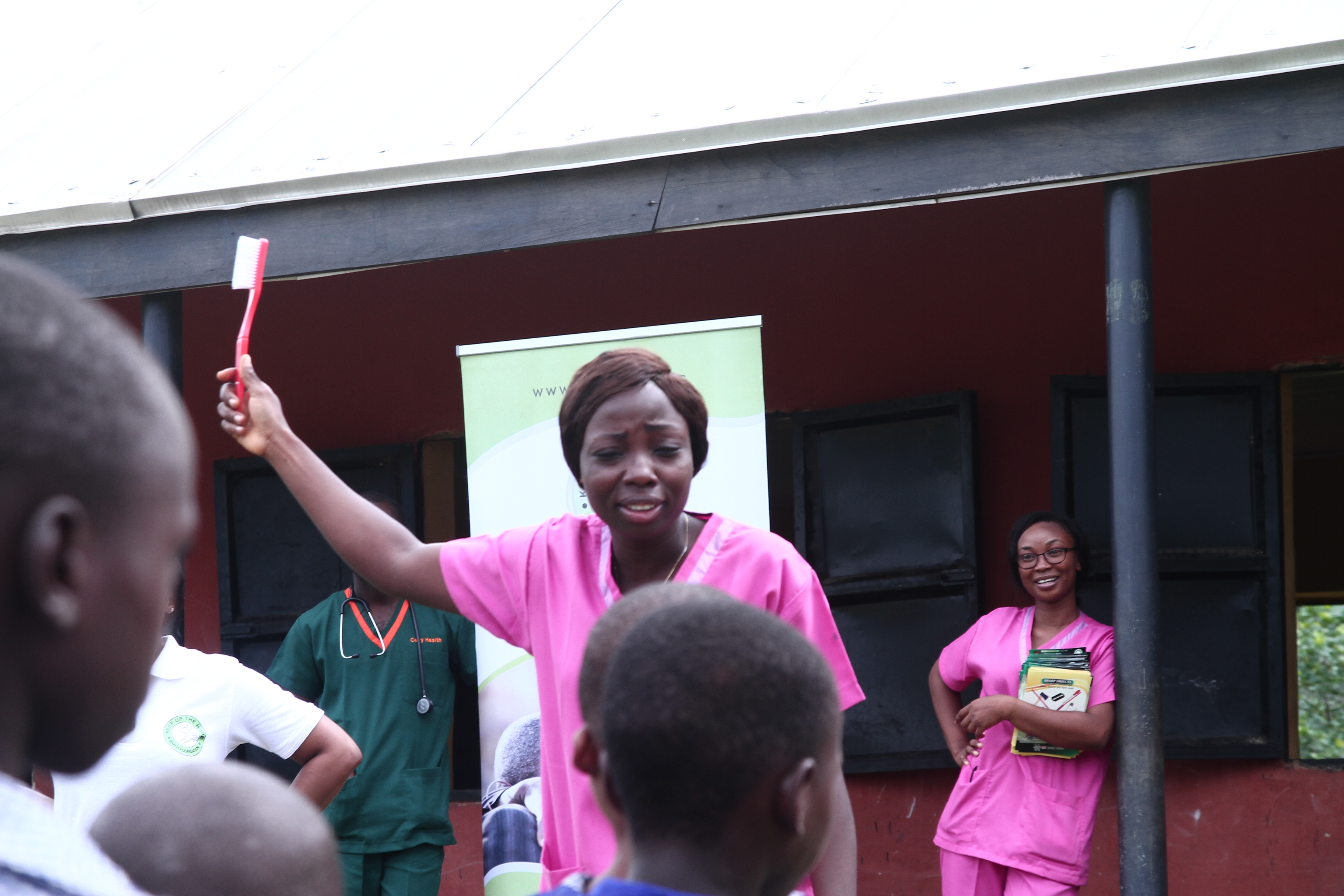 Female team member teaching children about dental hygiene