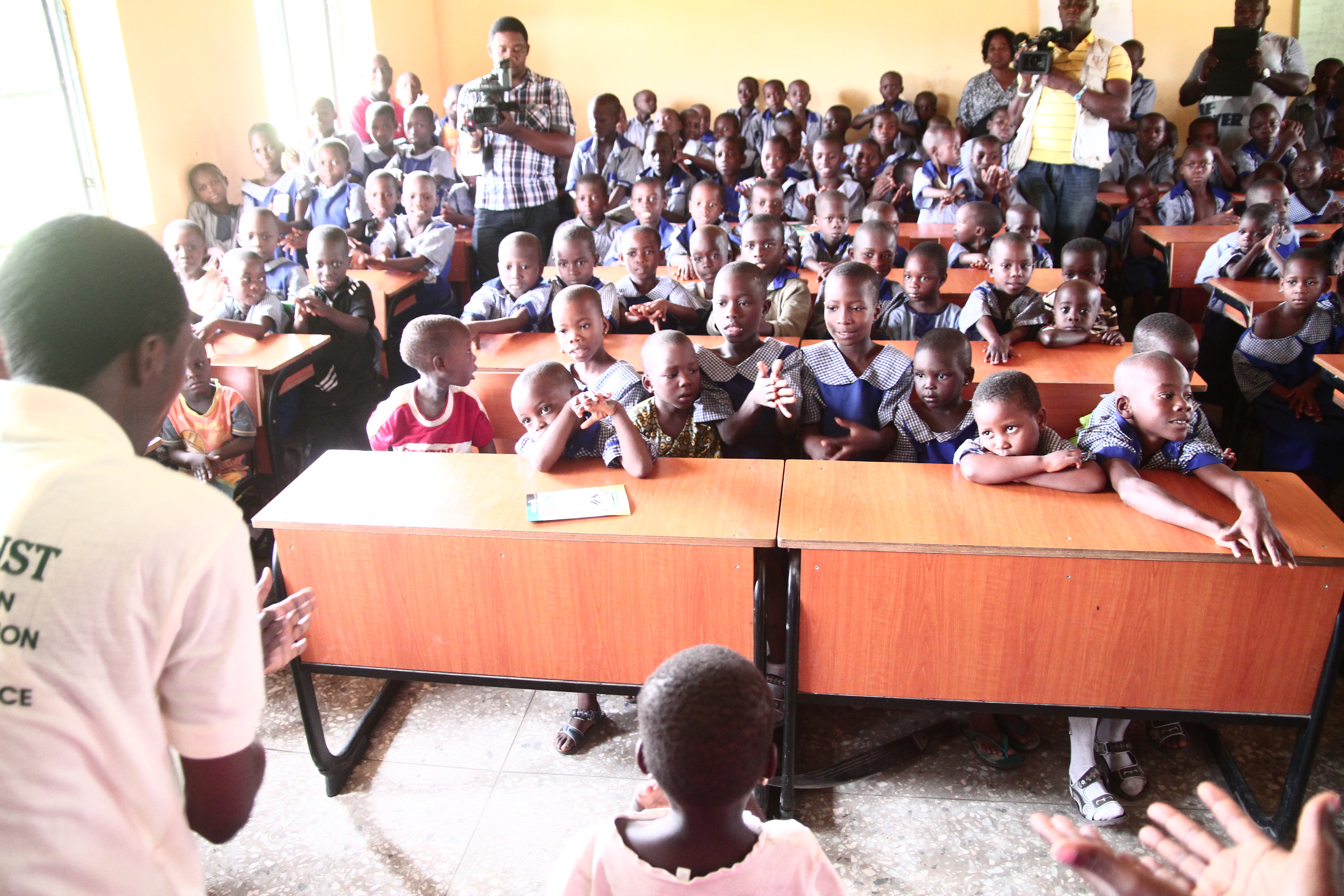 Team member addressing classroom of children