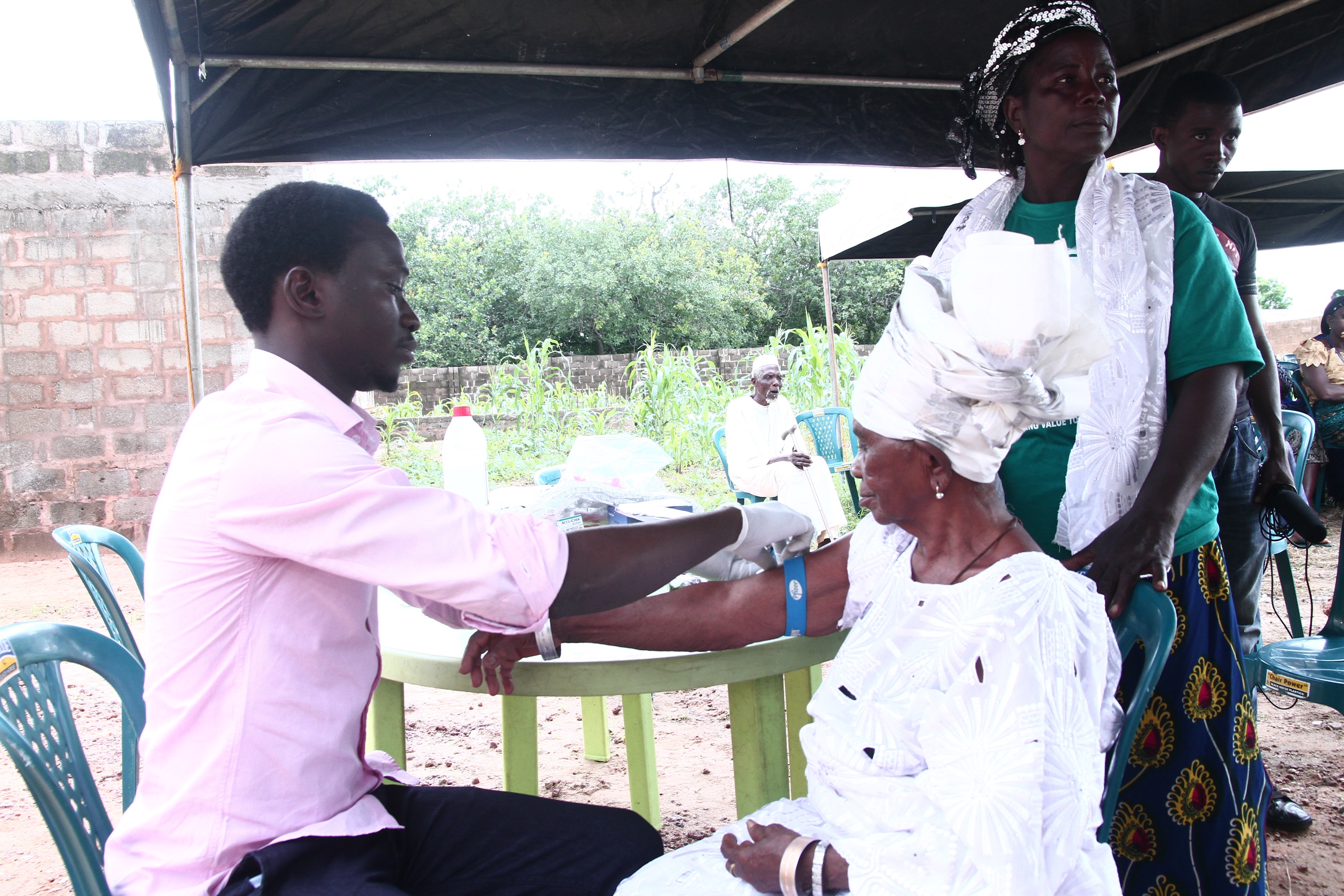 Healthcare worker drawing blood from elderly woman