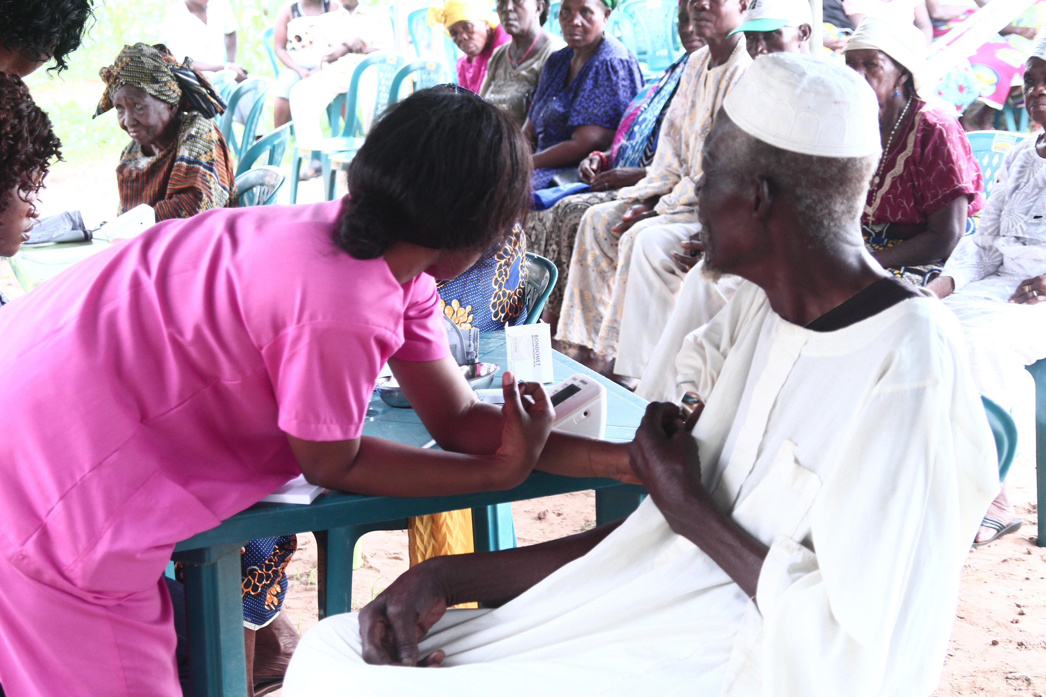 Elder man with grandchild getting blood pressure read