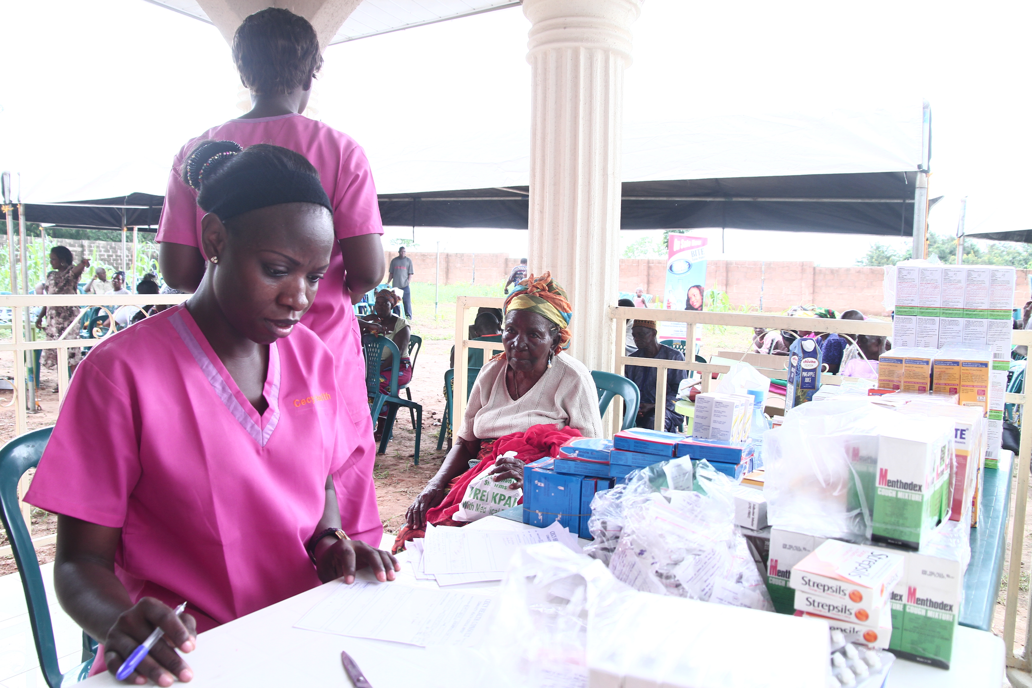 Blood pressure check on elderly man in traditional attire