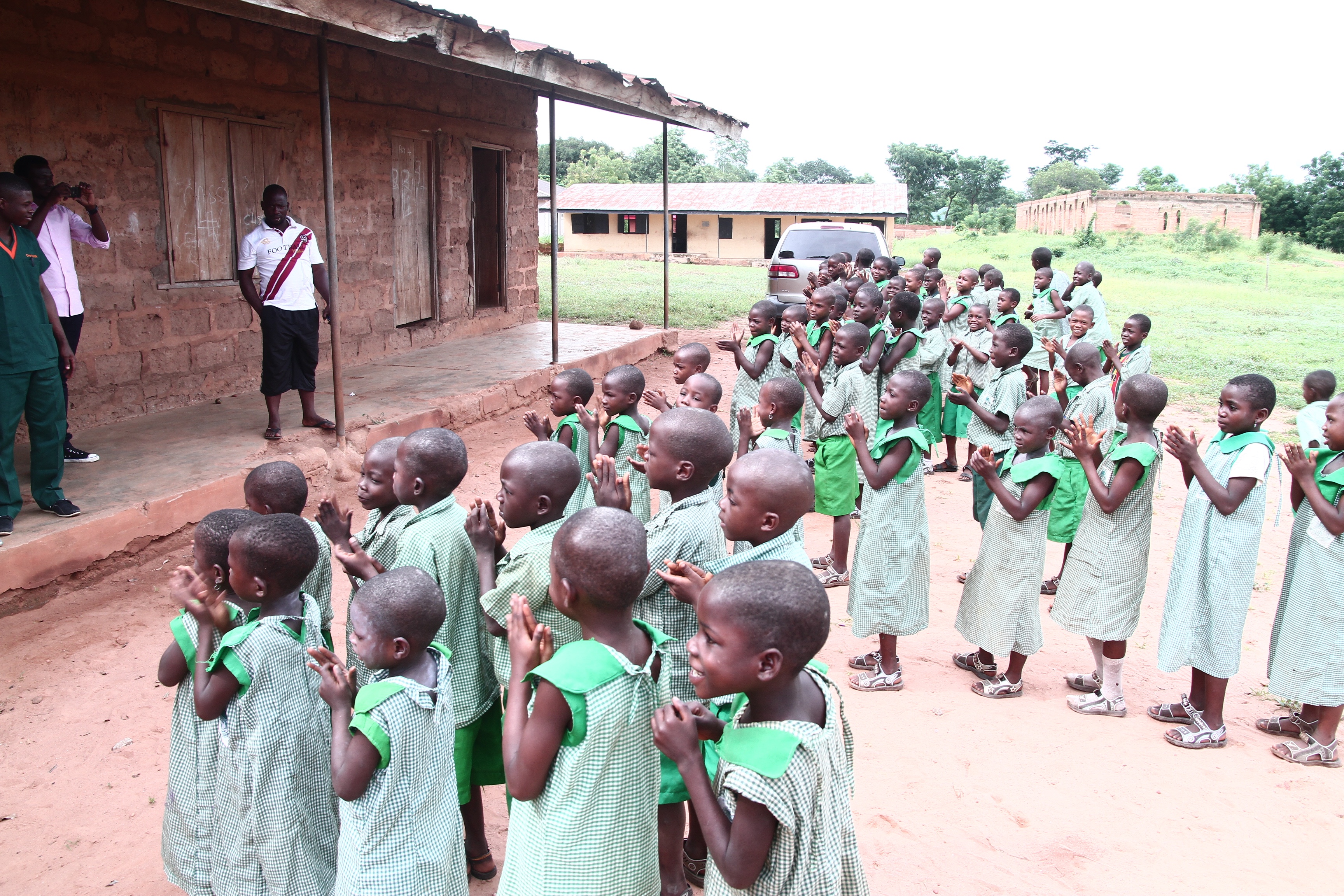 Children clapping and singing during health education