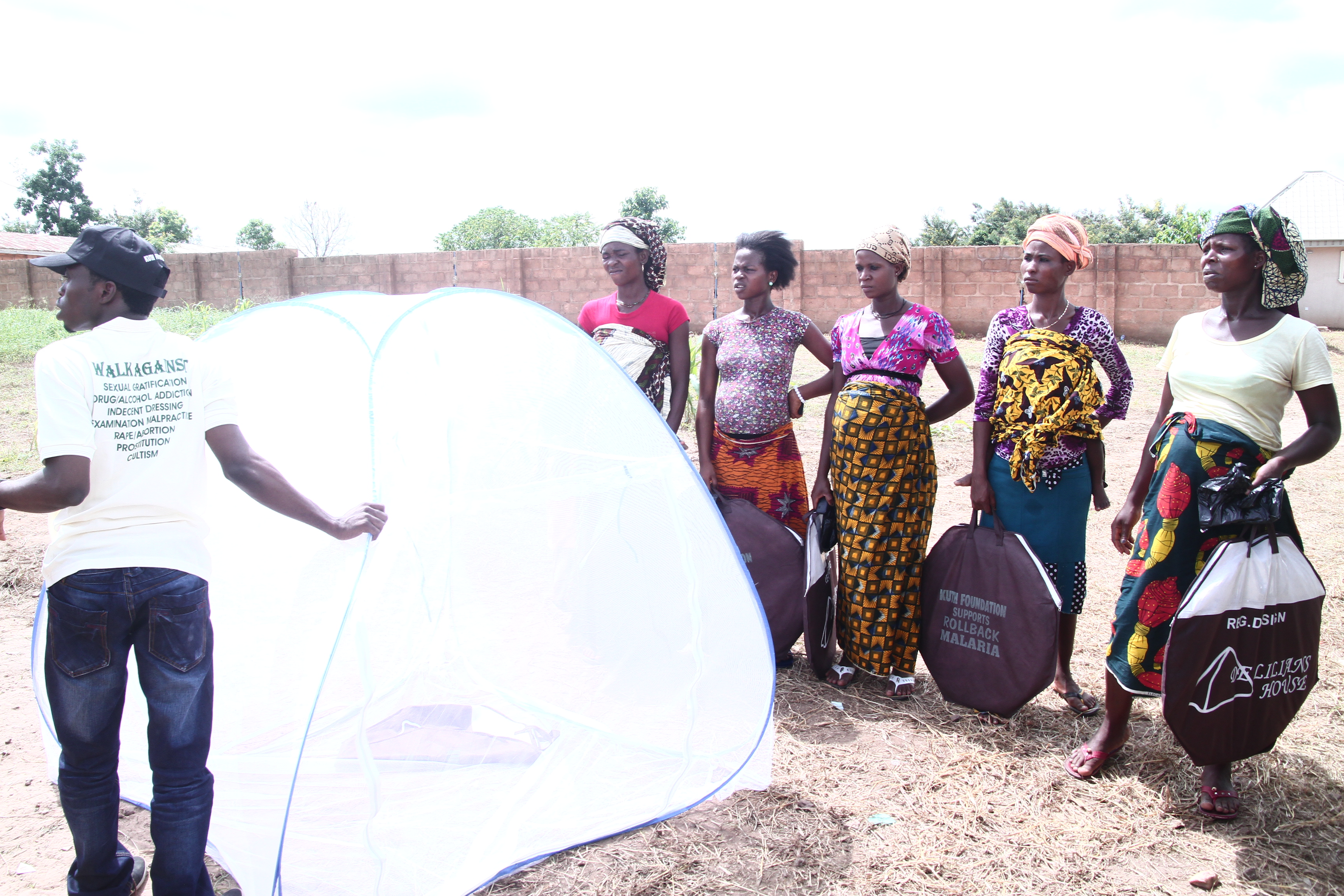 Mothers with children waiting under canopy for care