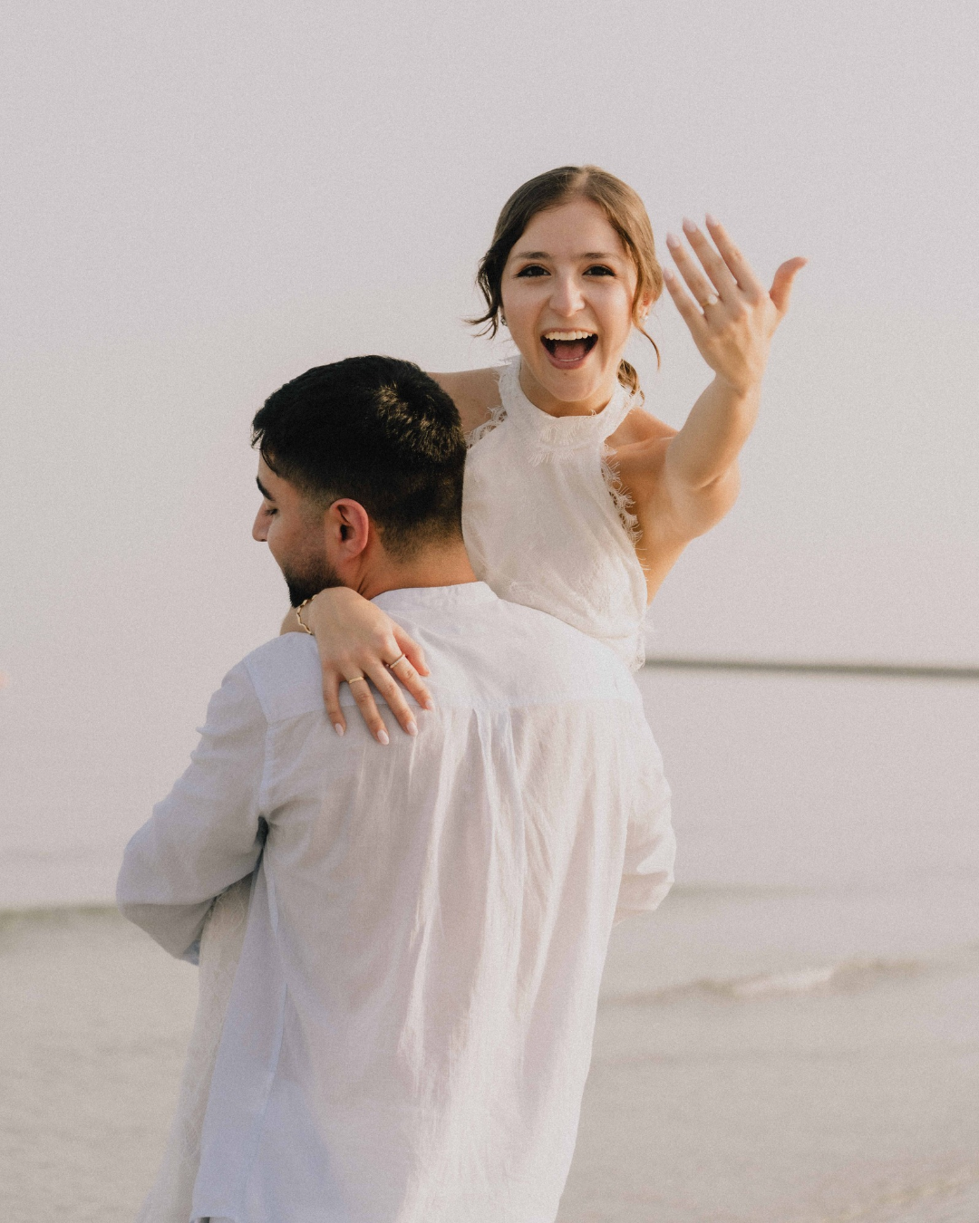 Newlywed couple celebrating together on the beach