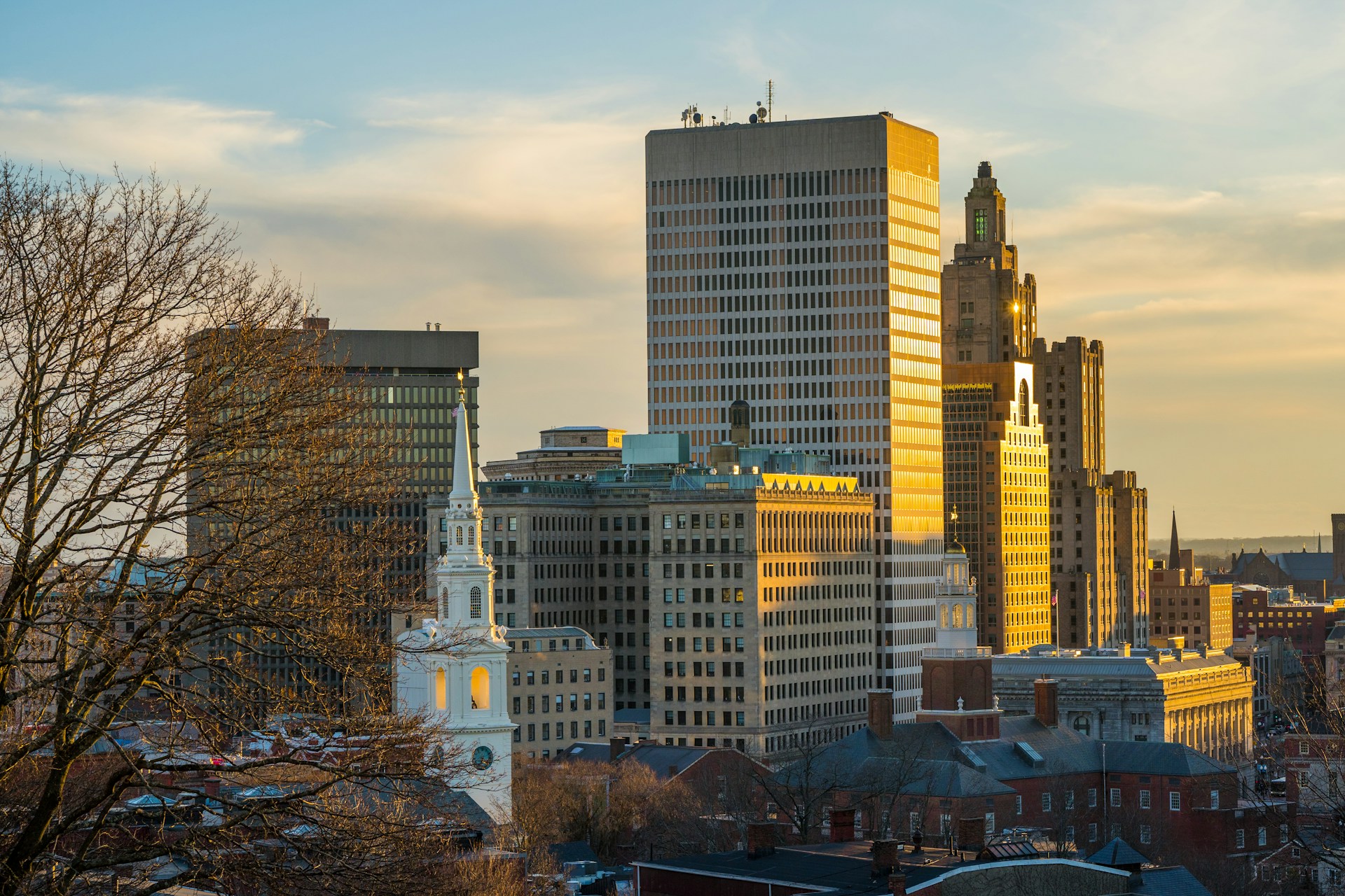 Providence, Rhode Island skyline at sunset with golden light reflecting off buildings