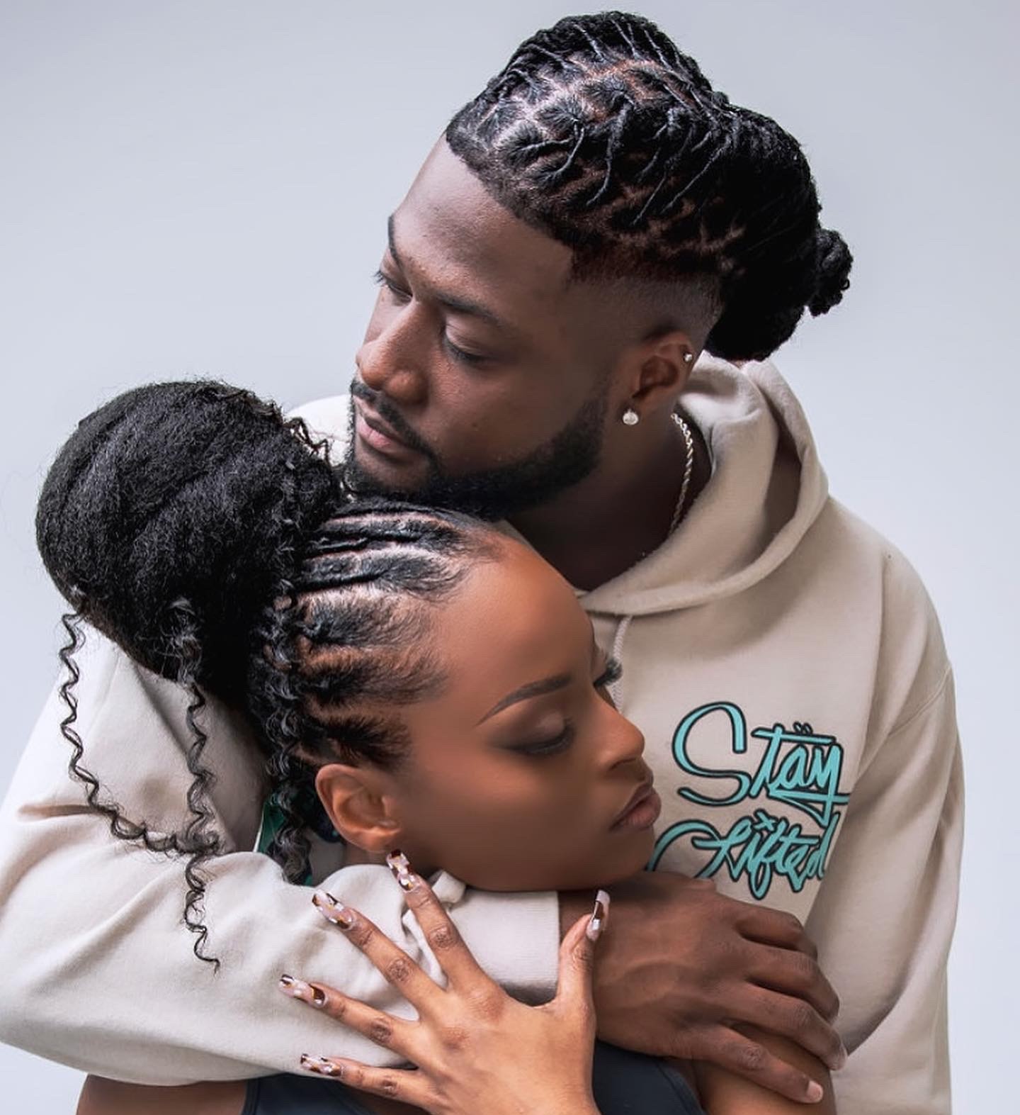 Couple wearing locs and braided ponytail