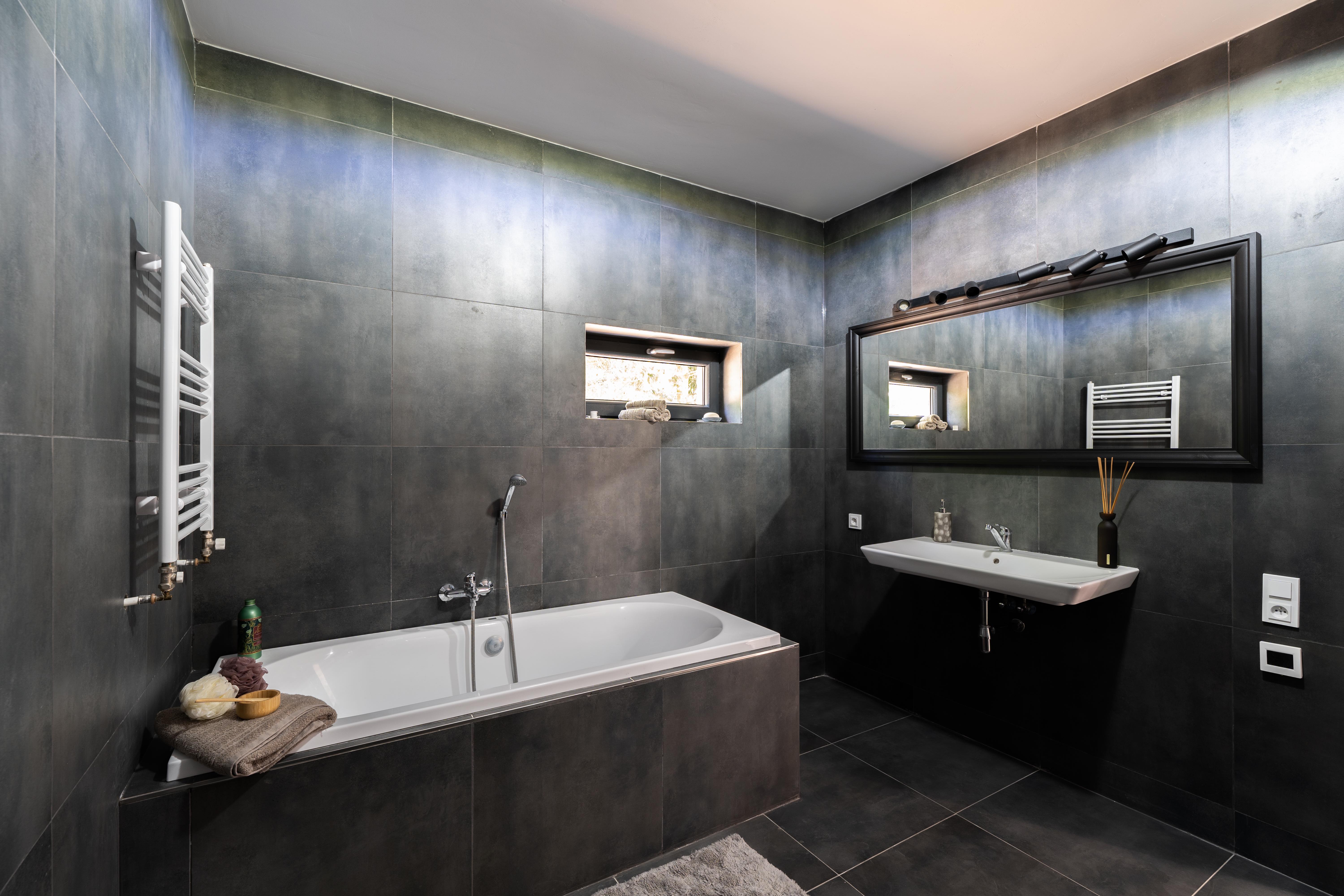 Bathroom with tub and mirror