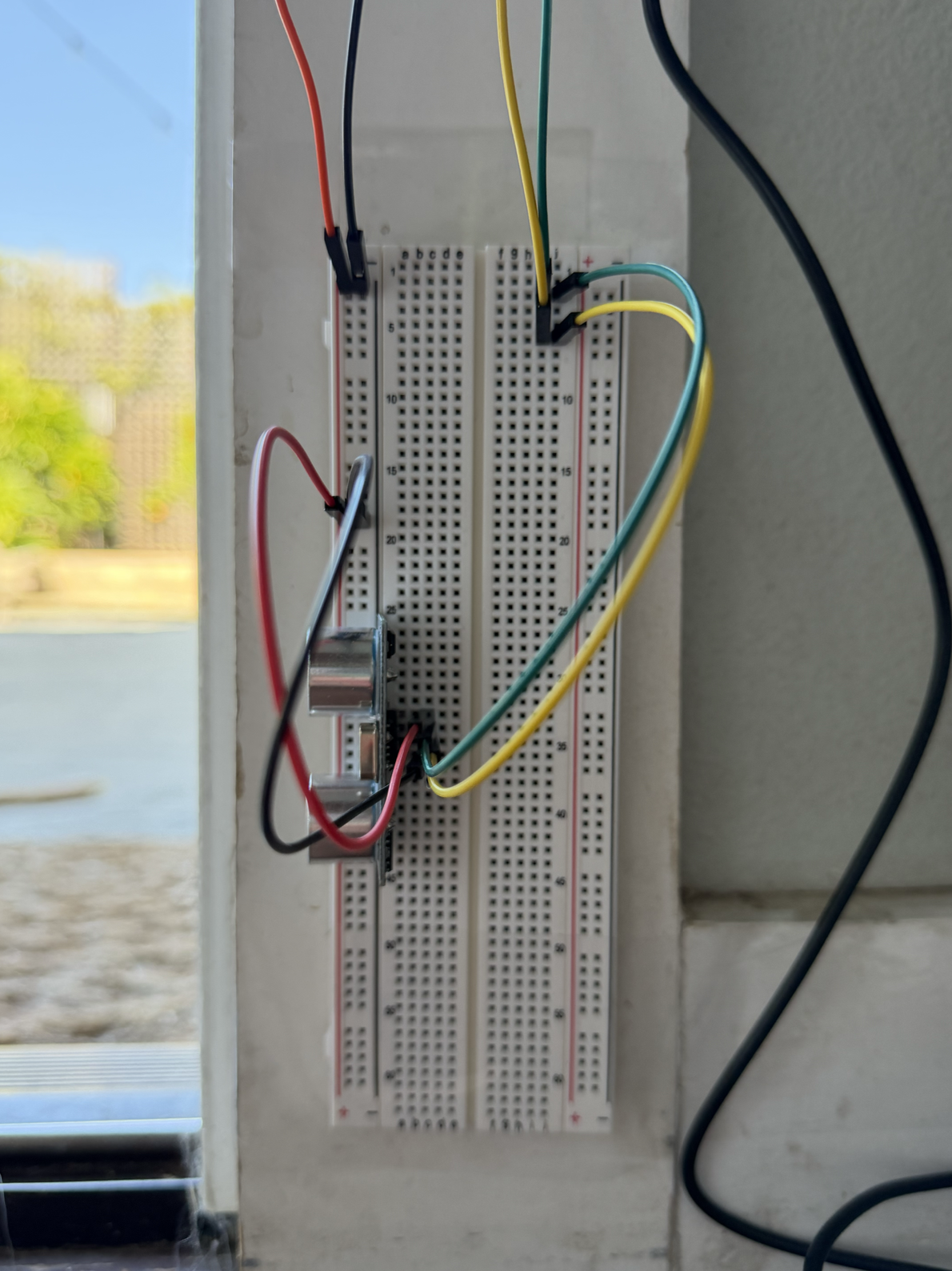 Low sensor mounted near the floor of the doorway