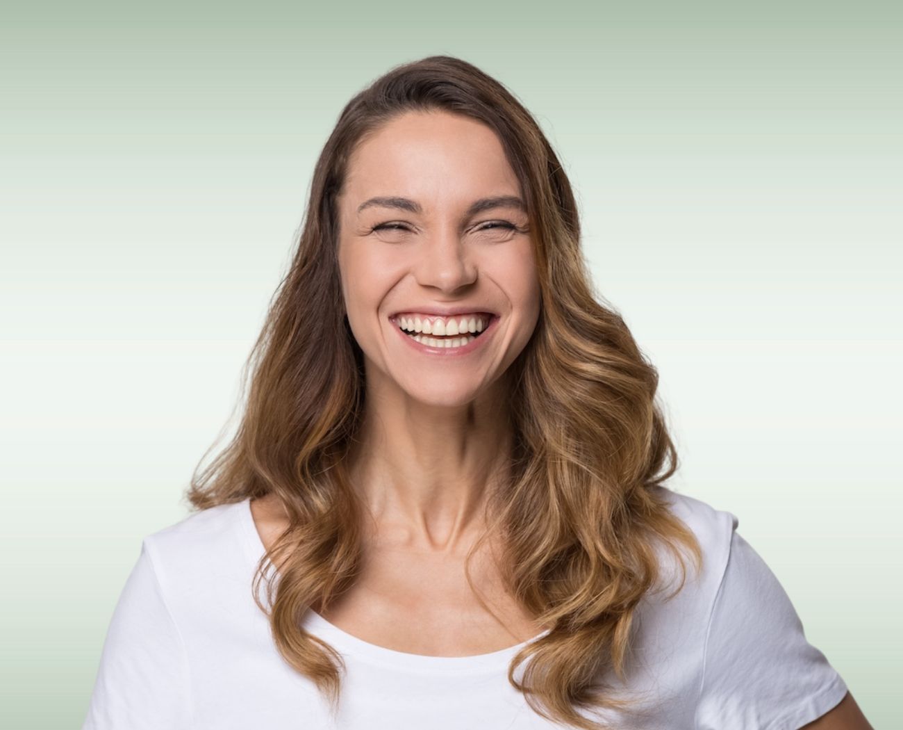 Happy patient with a beautiful smile after dental crown treatment