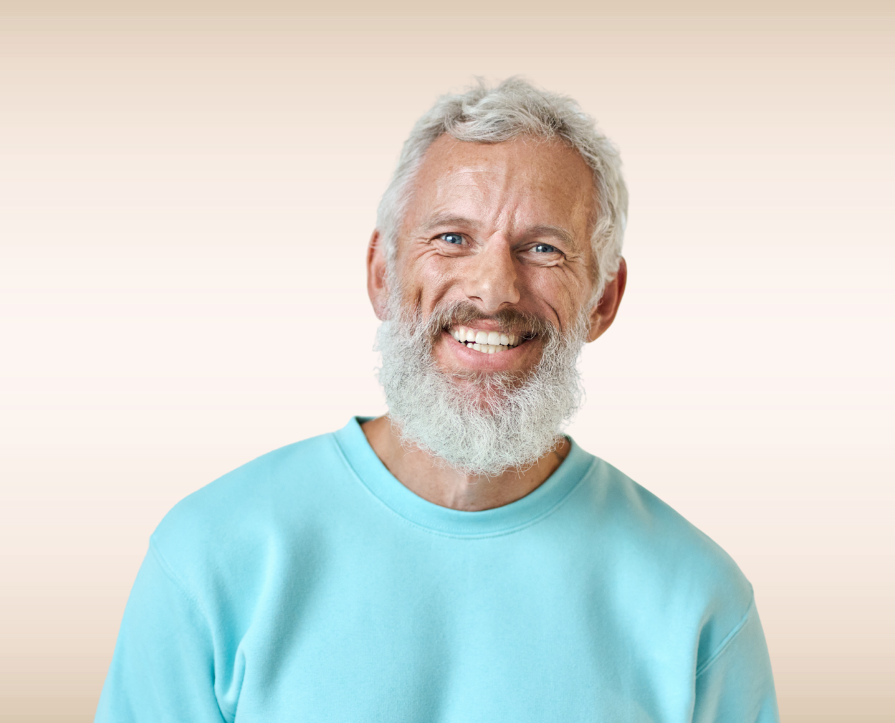 Smiling man with gray beard after TMJ treatment