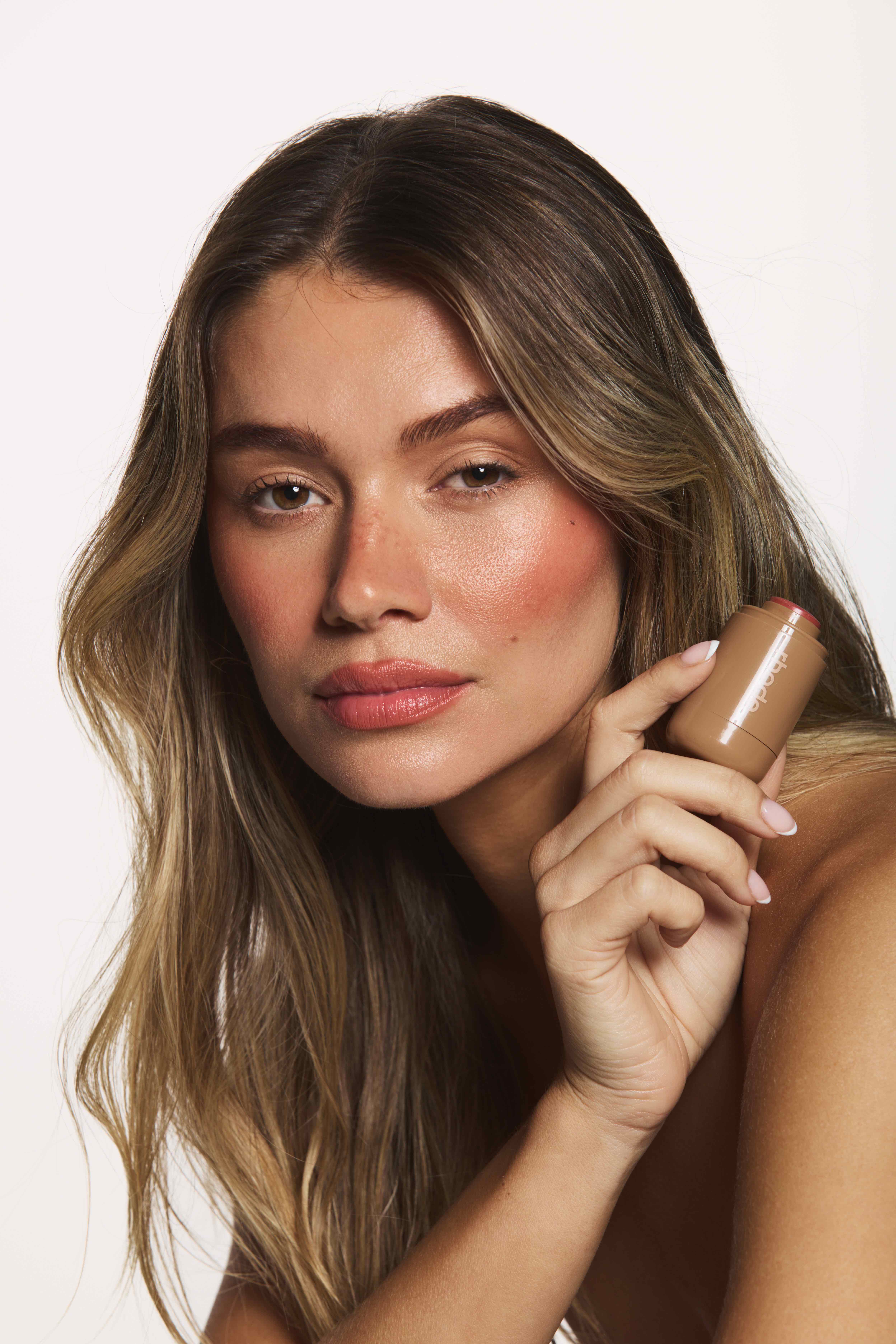 Studio beauty portrait with Rhode blush stick, product campaign