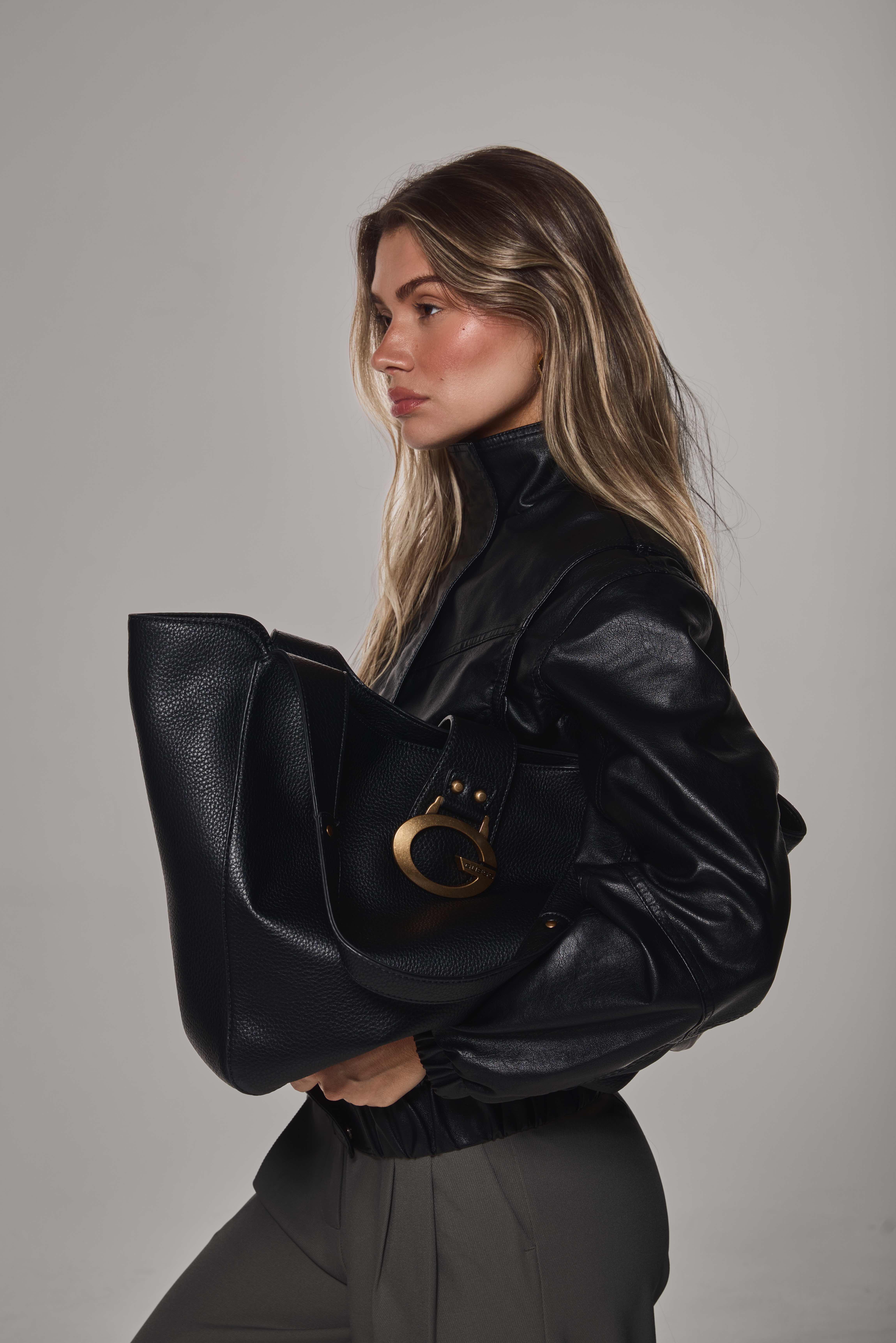 Mollie profile portrait holding GUESS bag