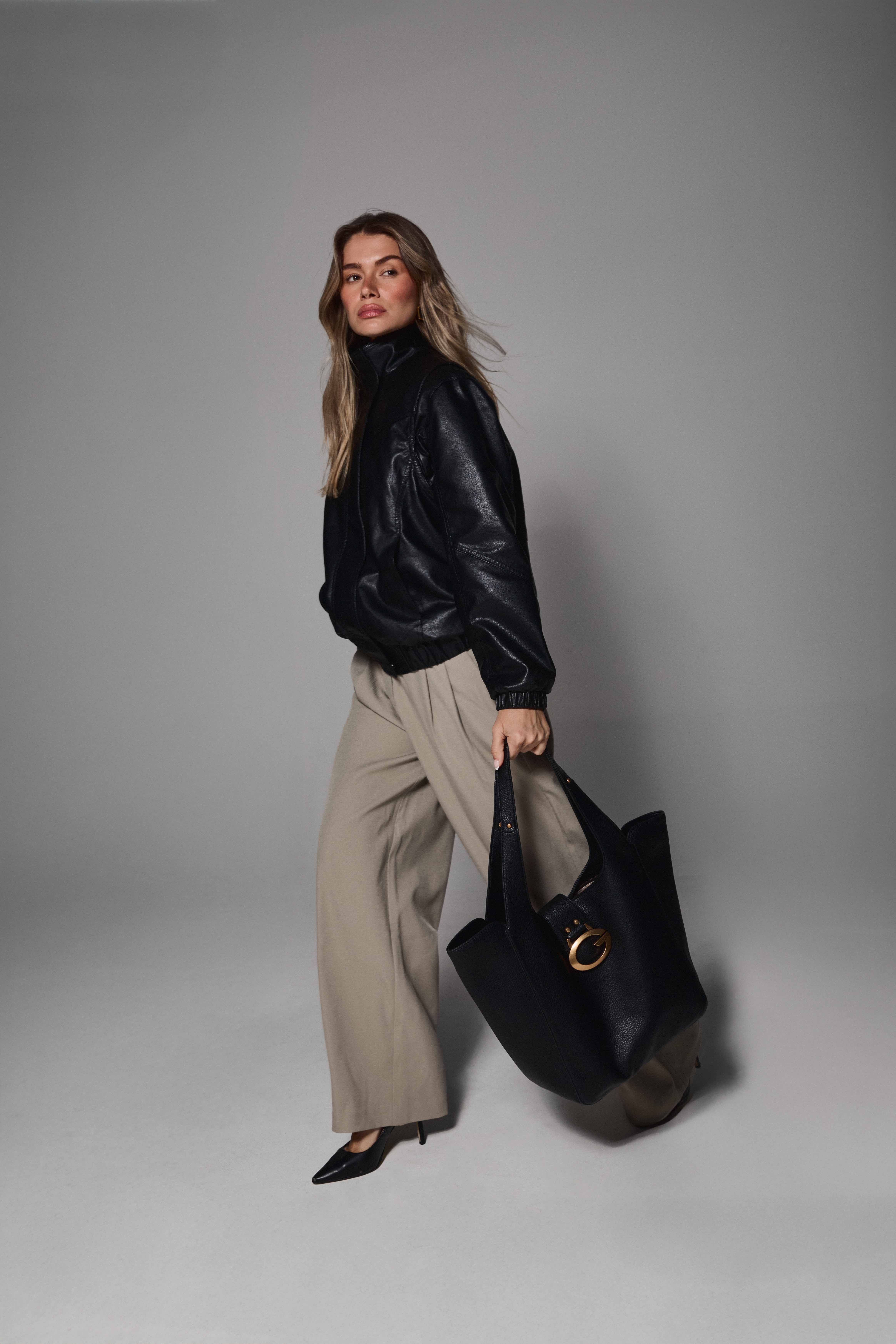Mollie walking with GUESS tote bag full length