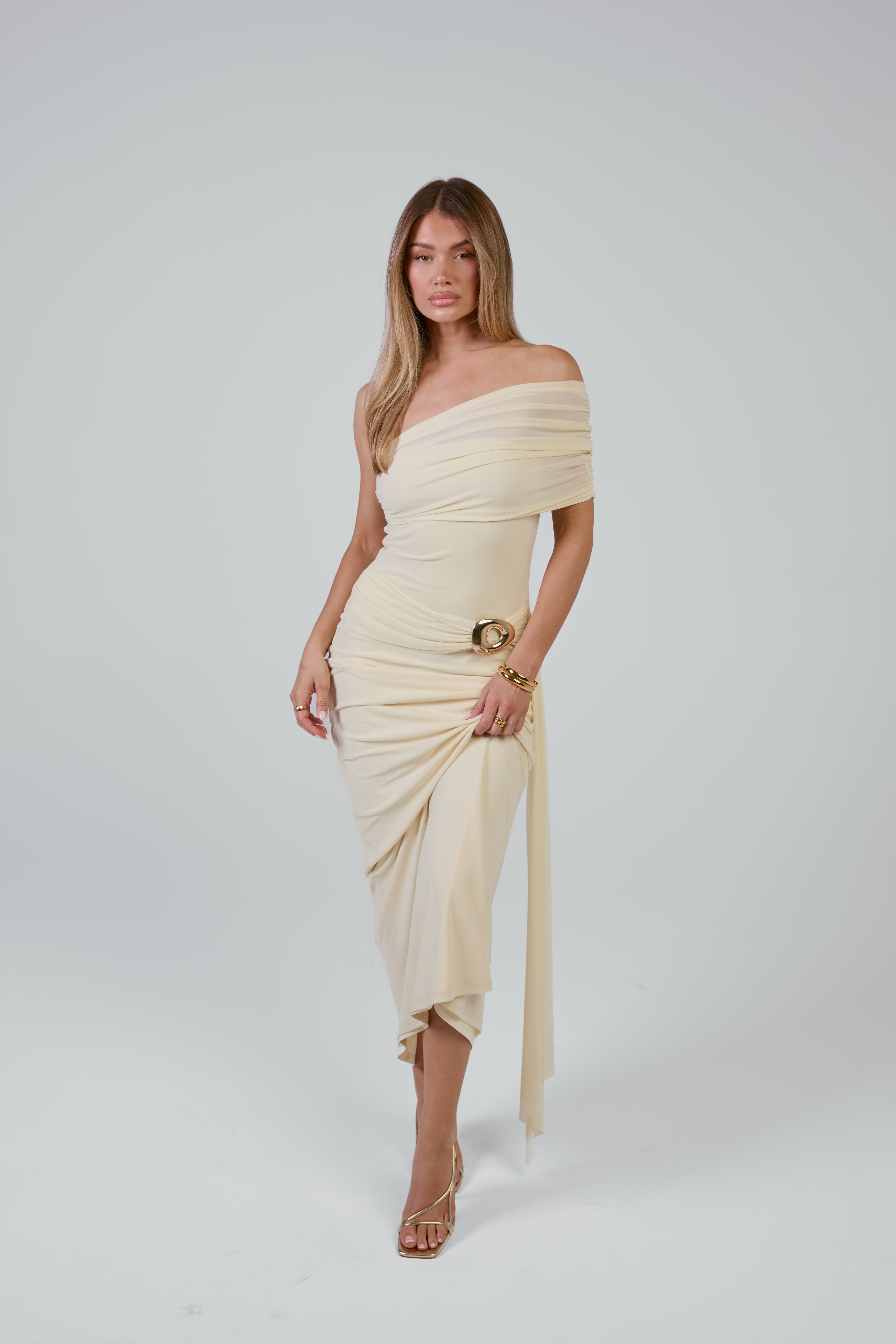 Mollie in cream off-shoulder draped midi dress with gold buckle
