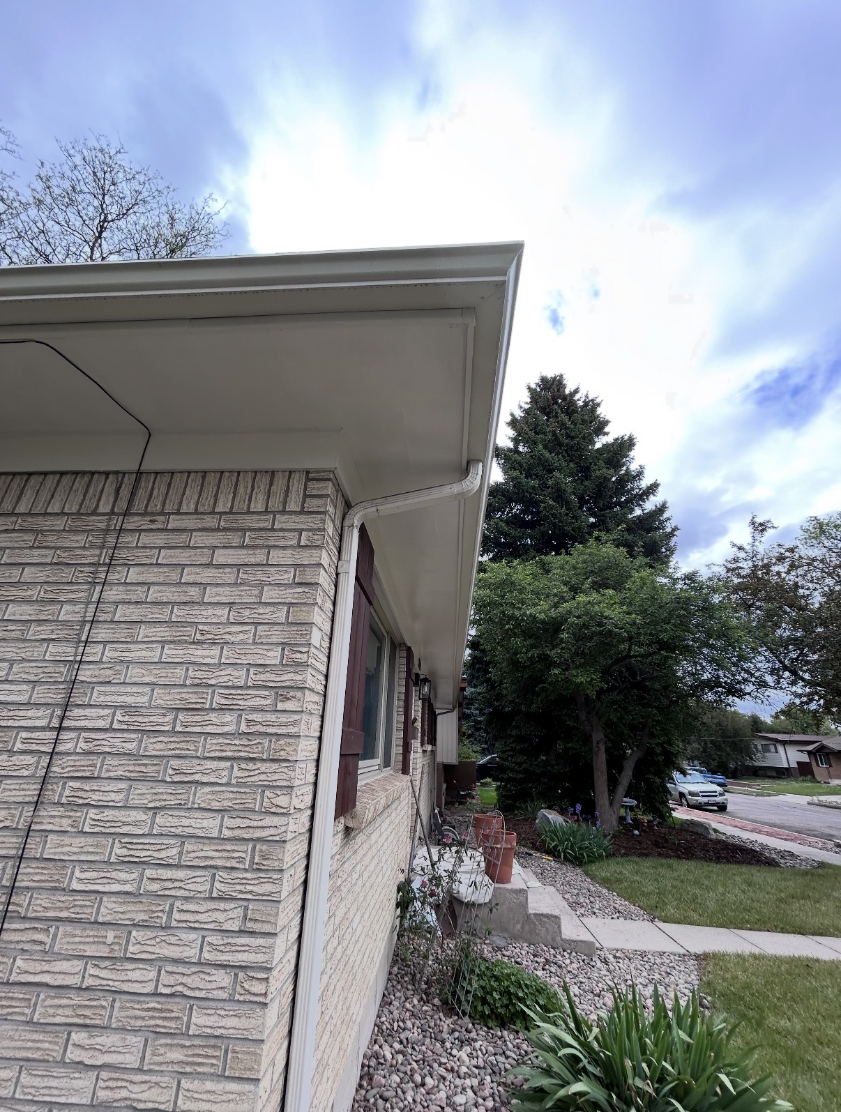 Exterior home painting with clean gutters and trim