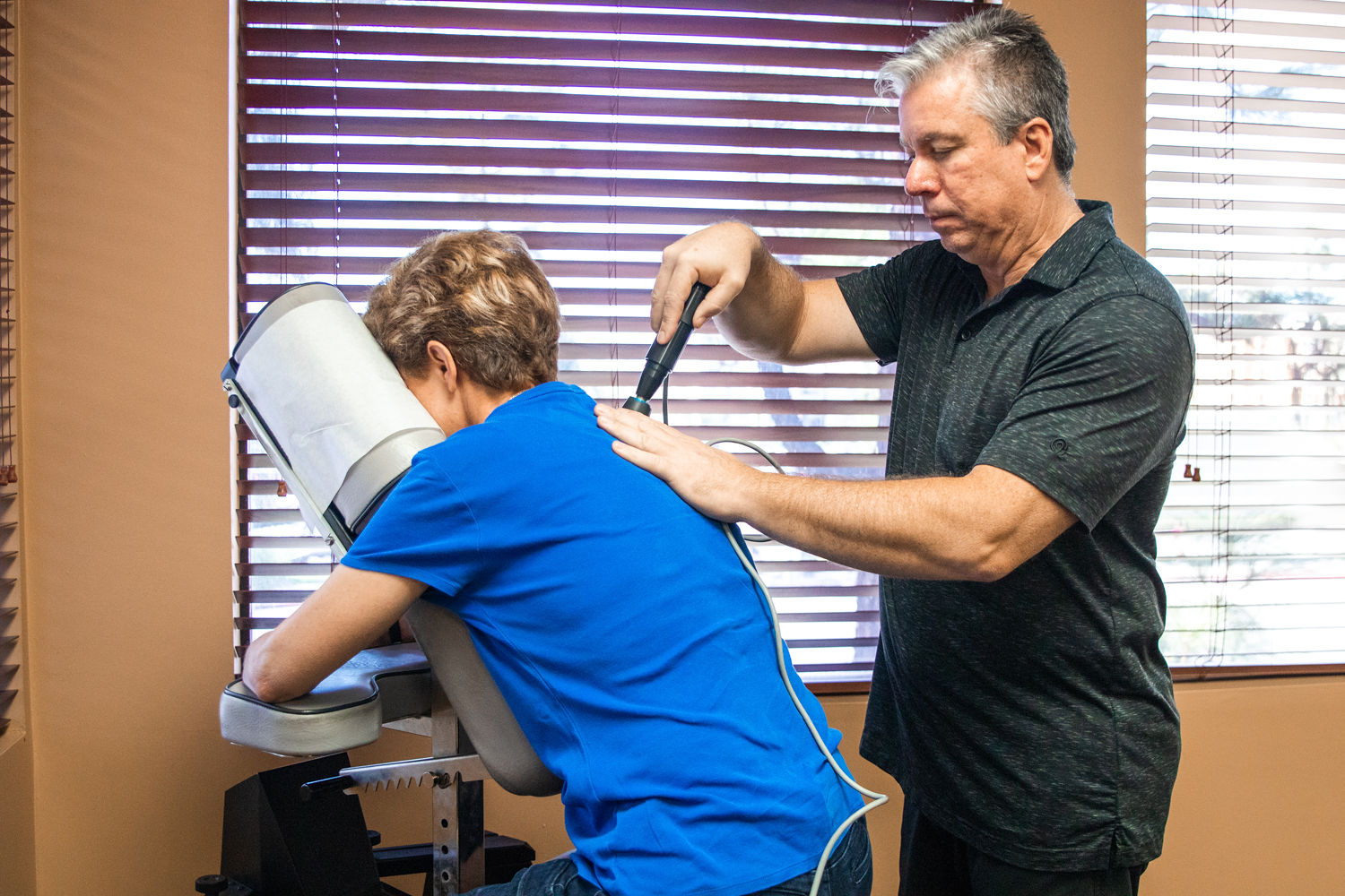 Professional chiropractor performing spinal adjustment