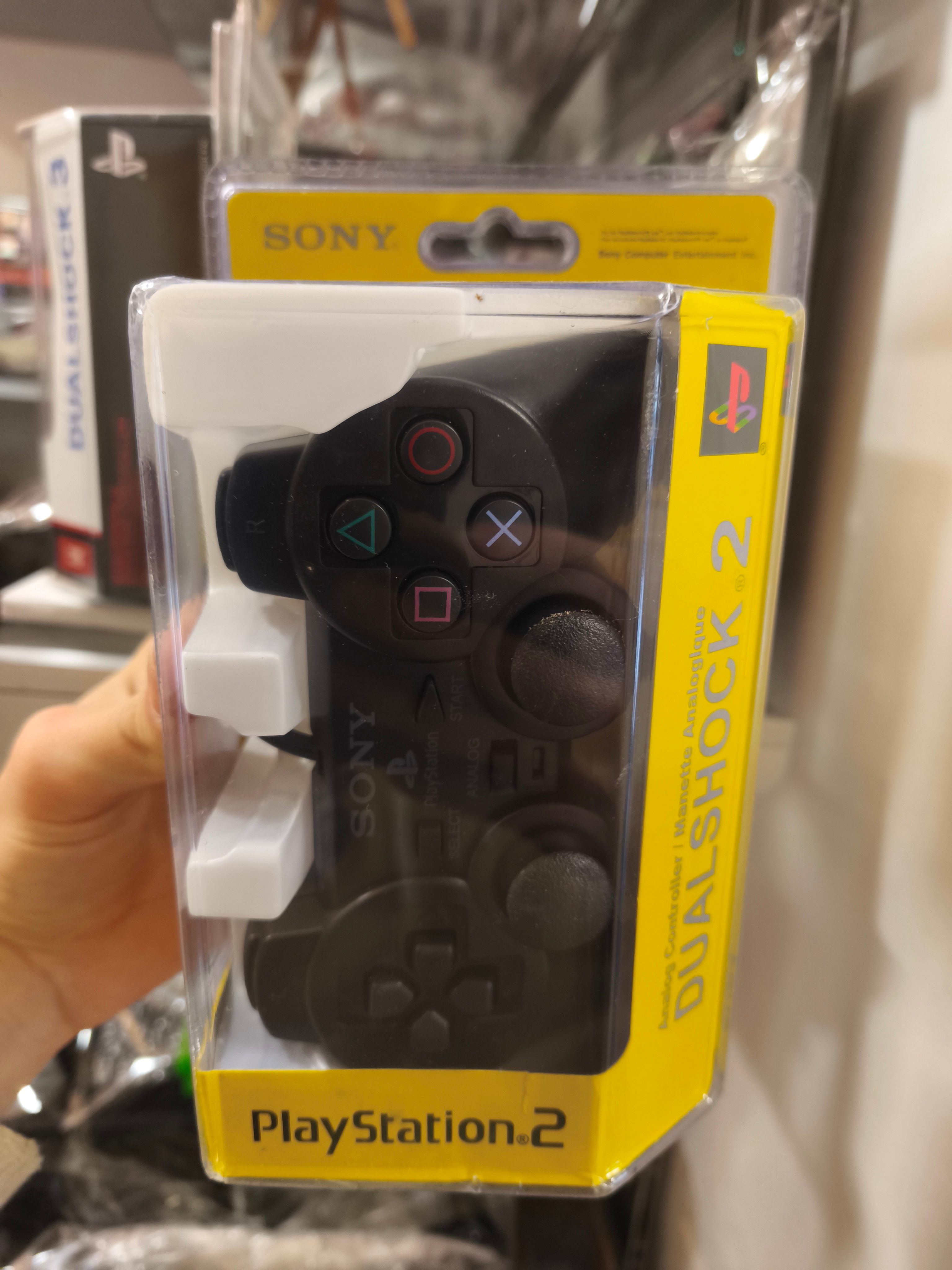 Manette Sony DualShock 2 PlayStation 2 PS2 noire neuve en boite jaune achat vente Game & Disc