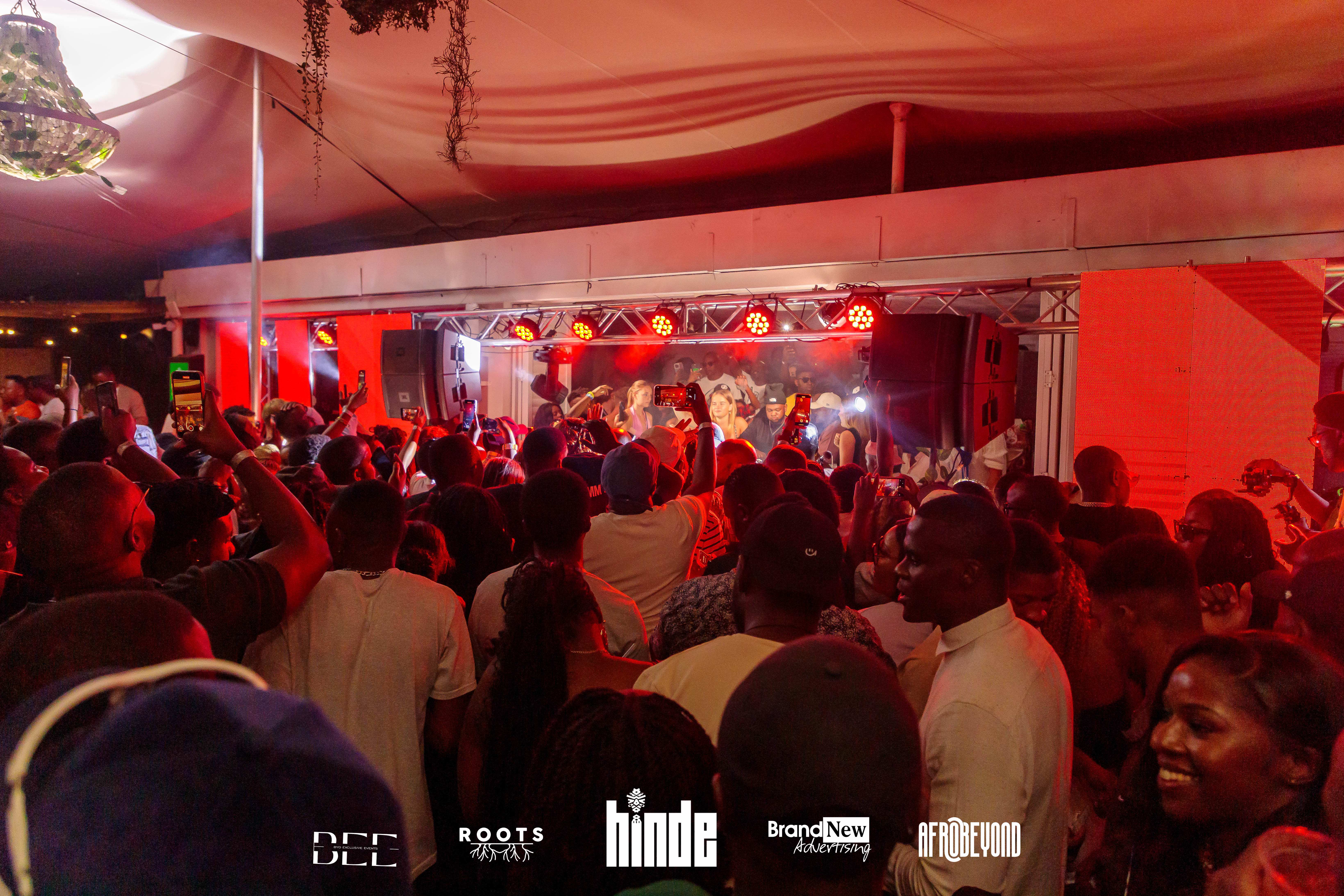 Concert with red lighting and packed audience