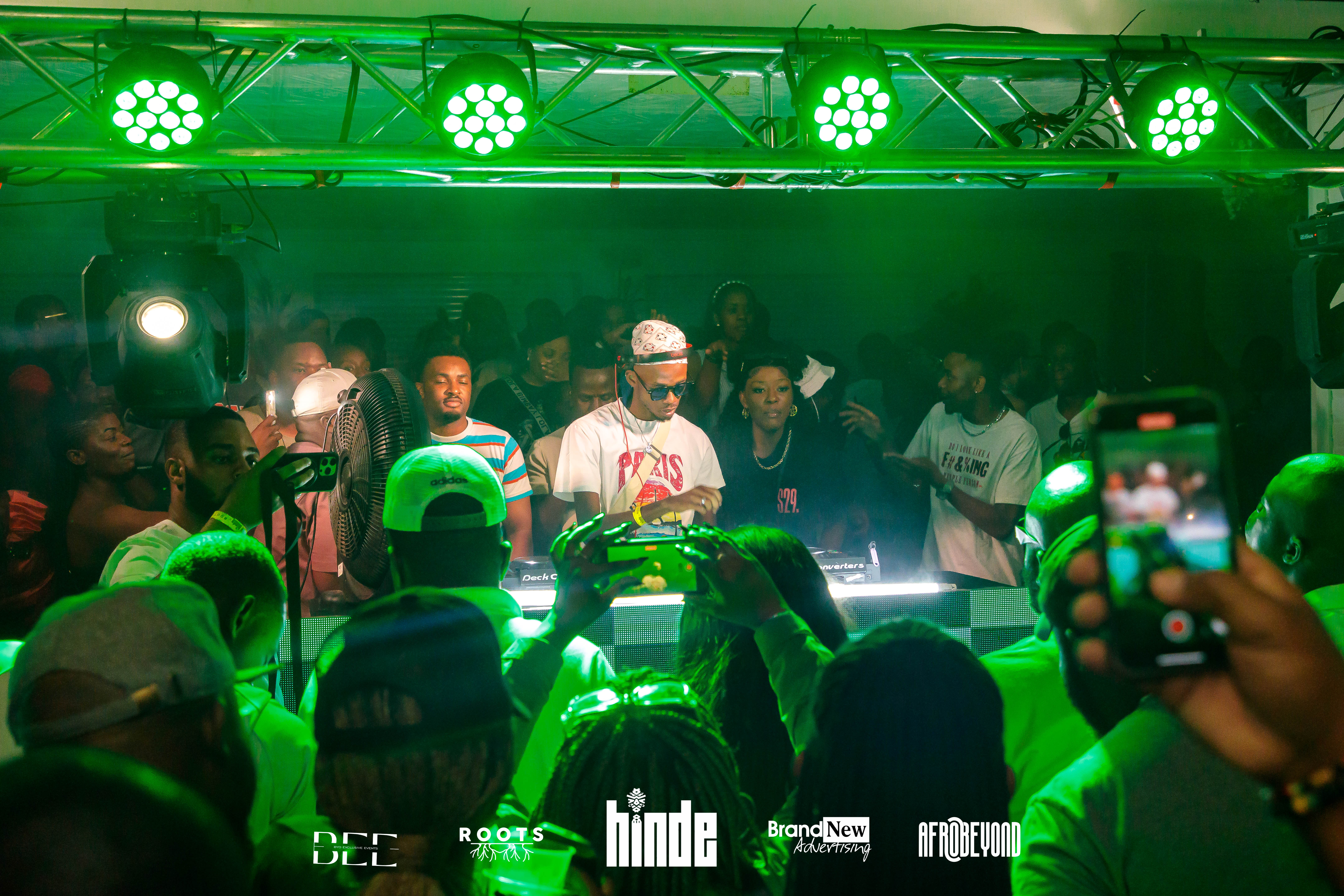 DJ performing with green stage lighting