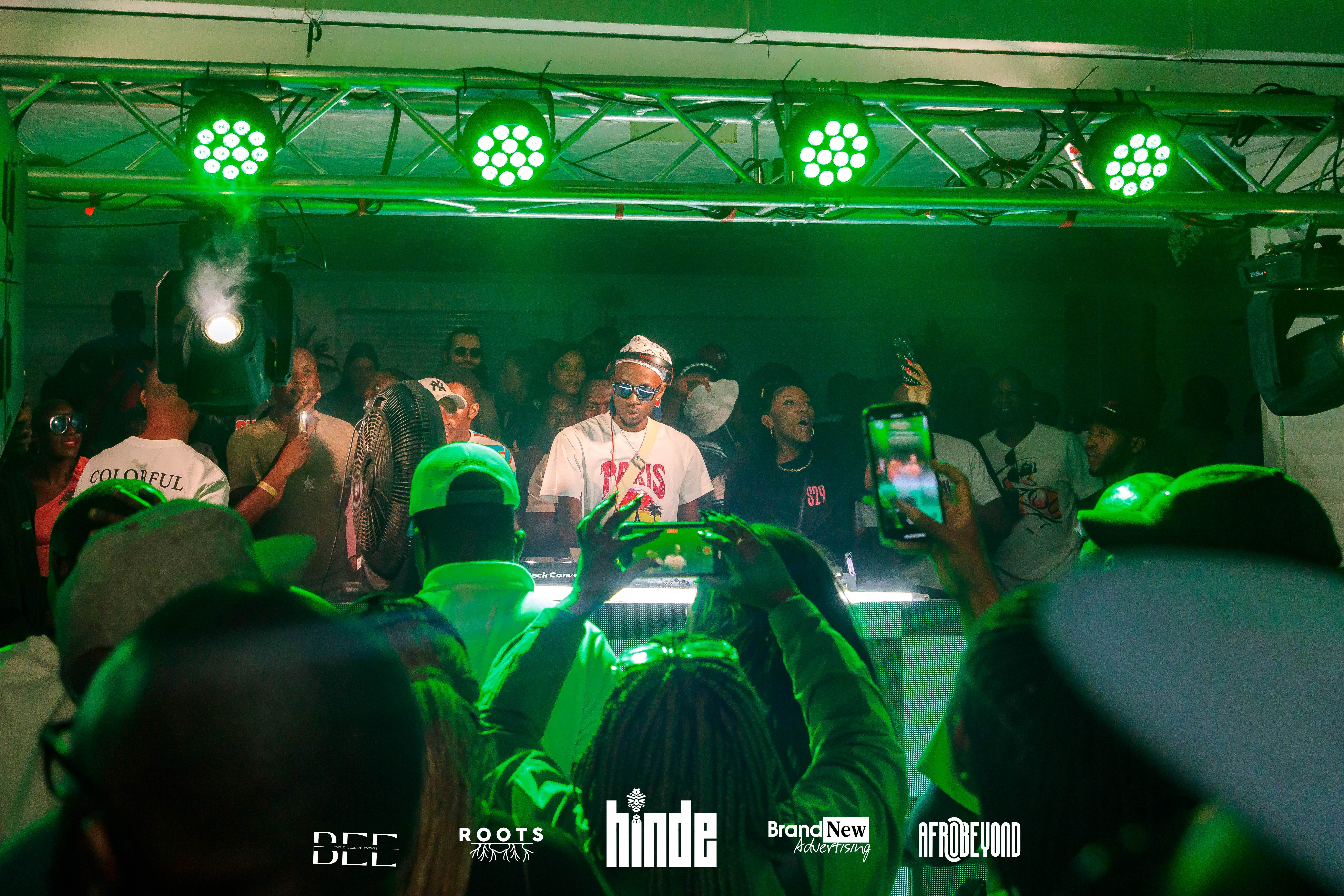 DJ performance with green lighting and crowd