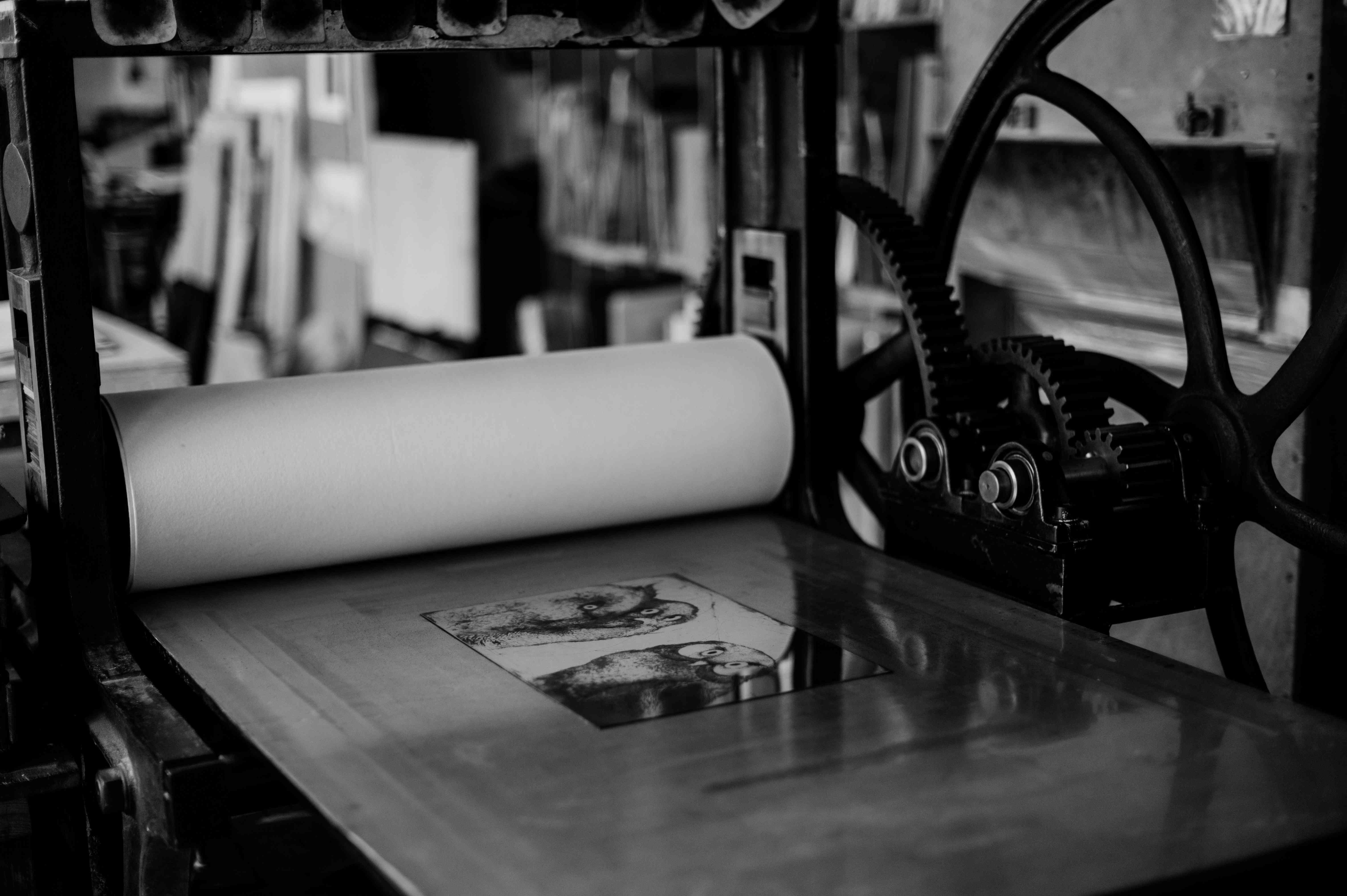 Owl plate set on the press bed beneath the felt blankets.