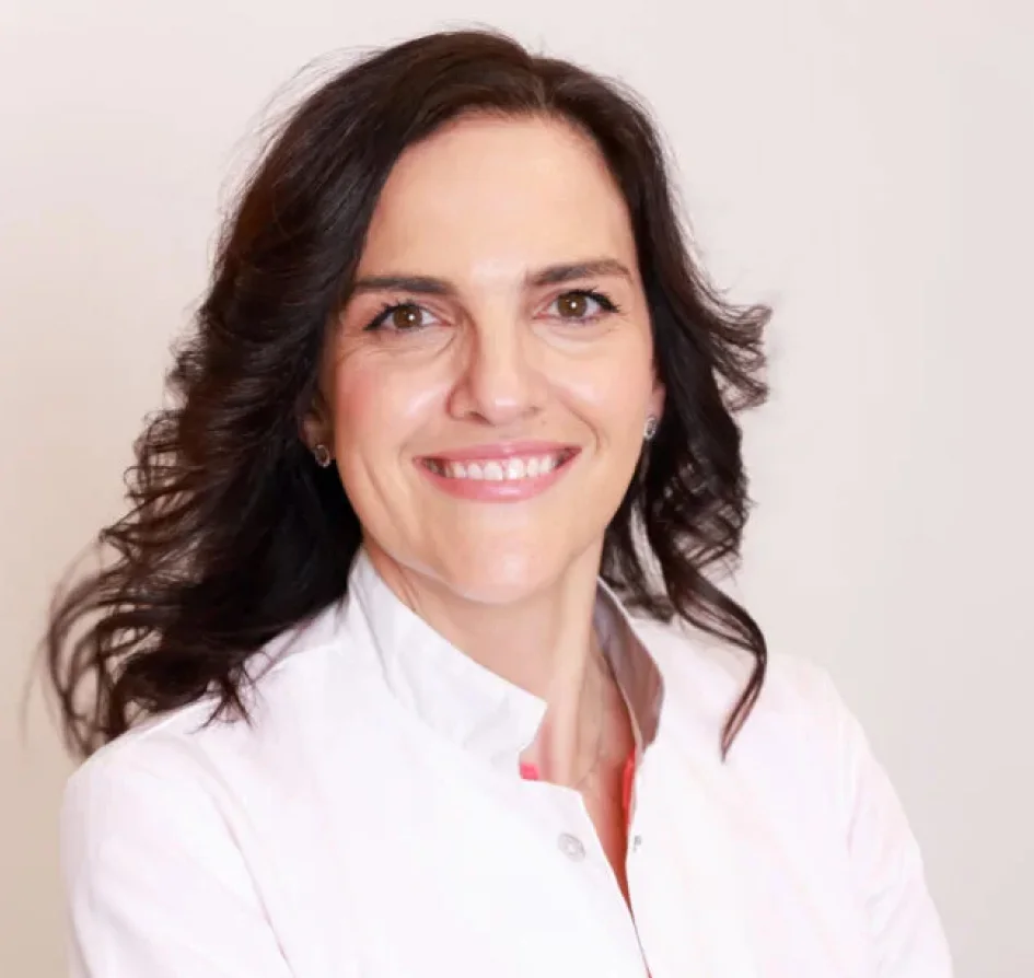 Mature woman smiling at sunset during menopause
