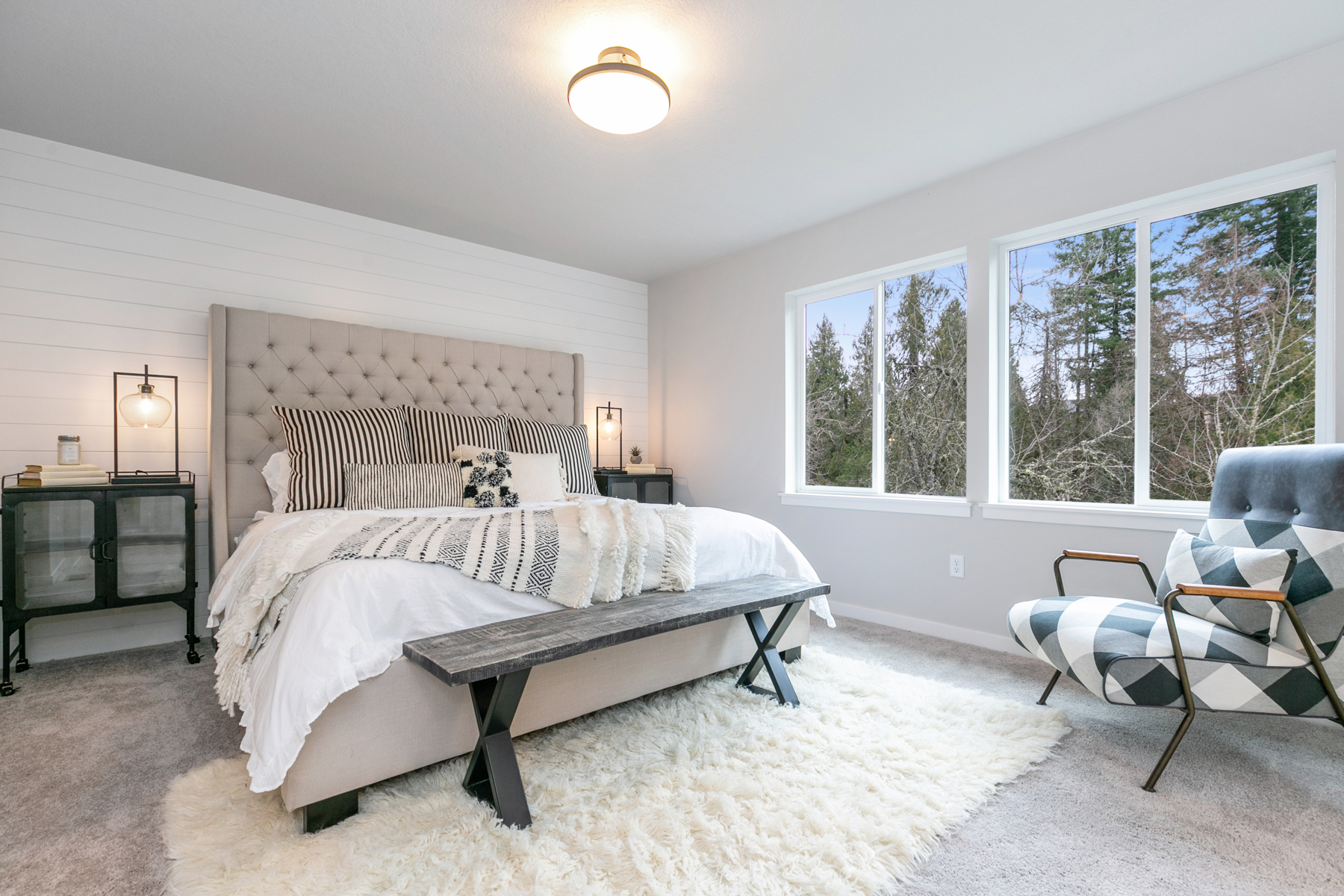 Professionally staged master bedroom with neutral tones and modern furnishings