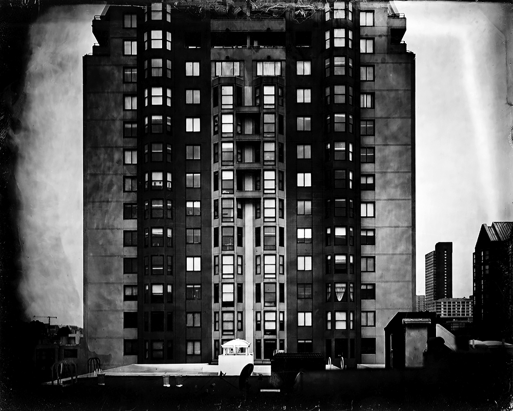 Architectural photograph of towering Art Deco building with geometric window patterns and dramatic sky