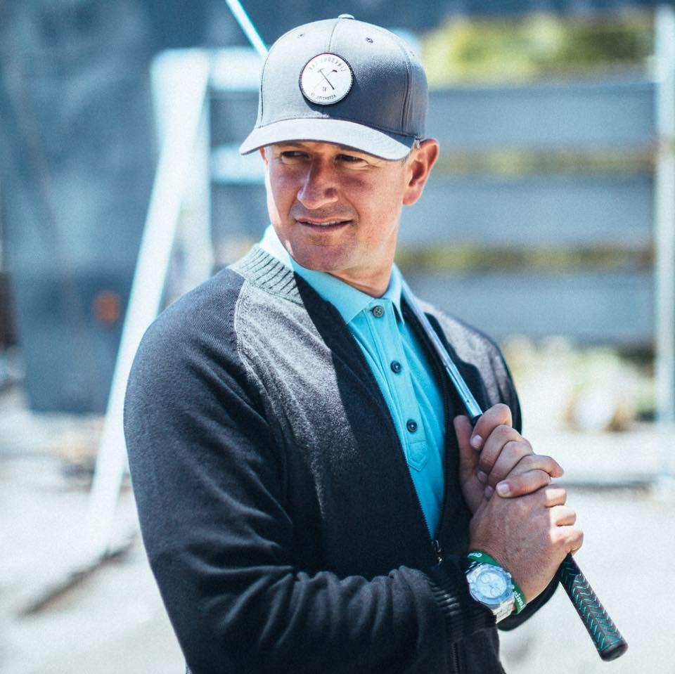 Matt Ginella portrait with gray snapback and teal polo