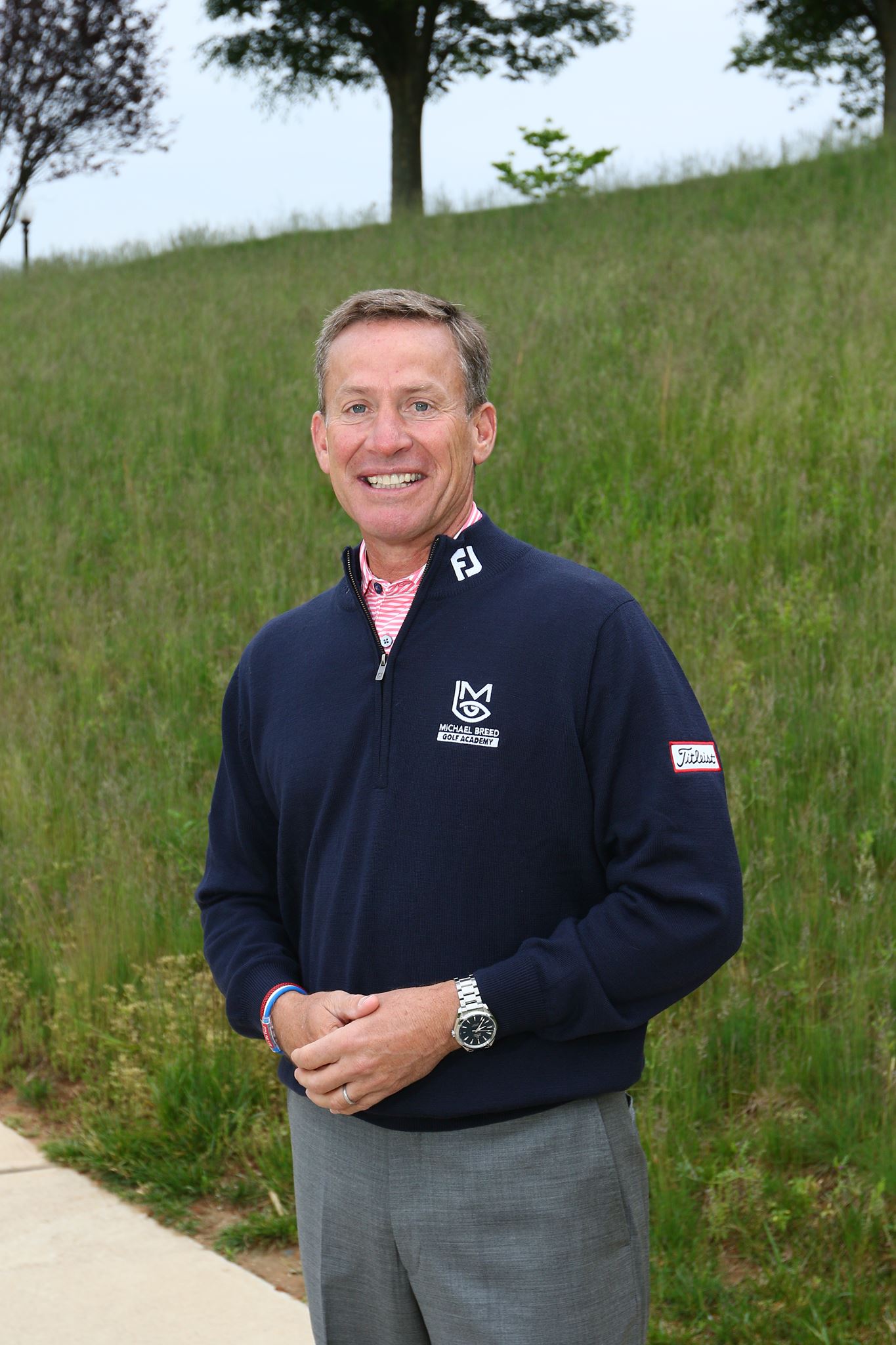 Michael Breed portrait in navy Michael Breed Golf Academy pullover