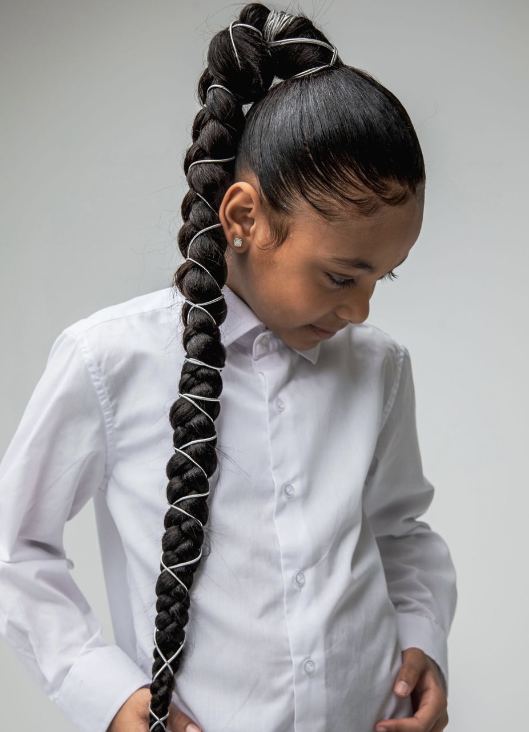 Young girl with sleek braided ponytail