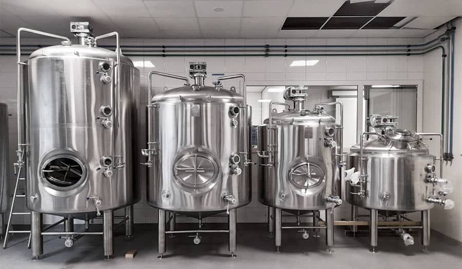 Four cylindrical mixing tanks in clean factory setting