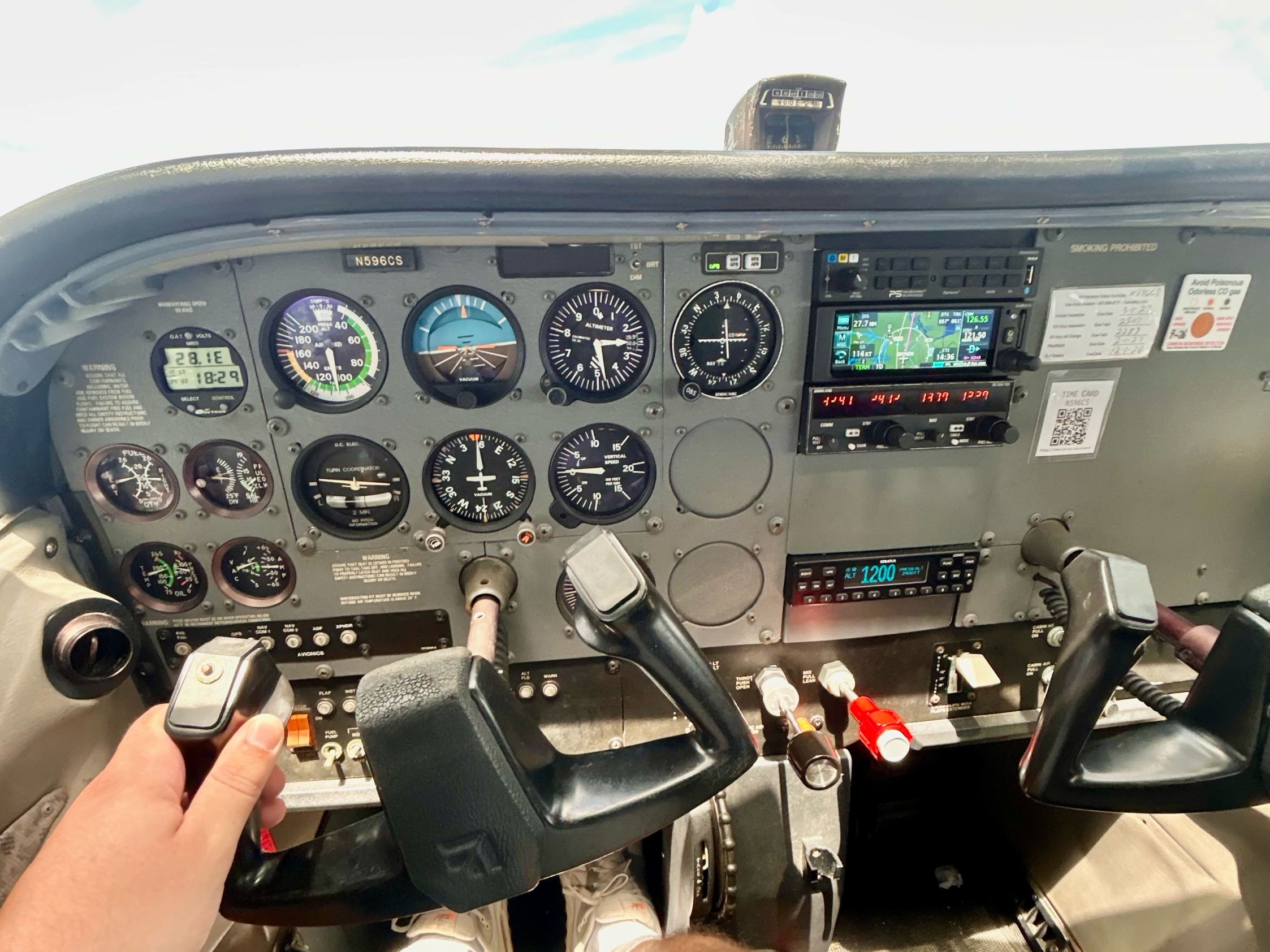 N596CS cockpit panel showing six-pack gauges, Garmin GNC 355, and Bendix King radio