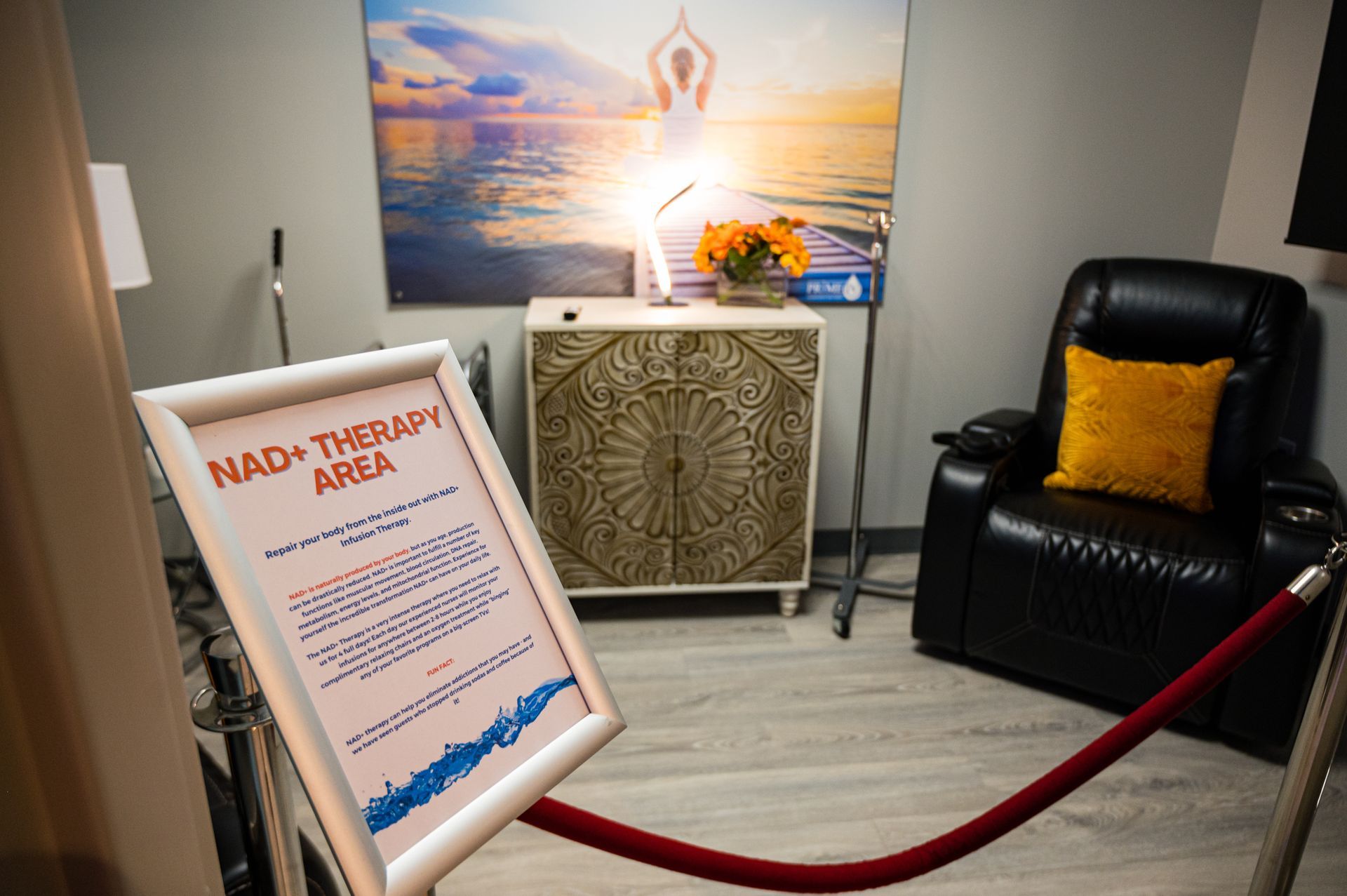The NAD+ Therapy area with a recliner and calming sunset artwork