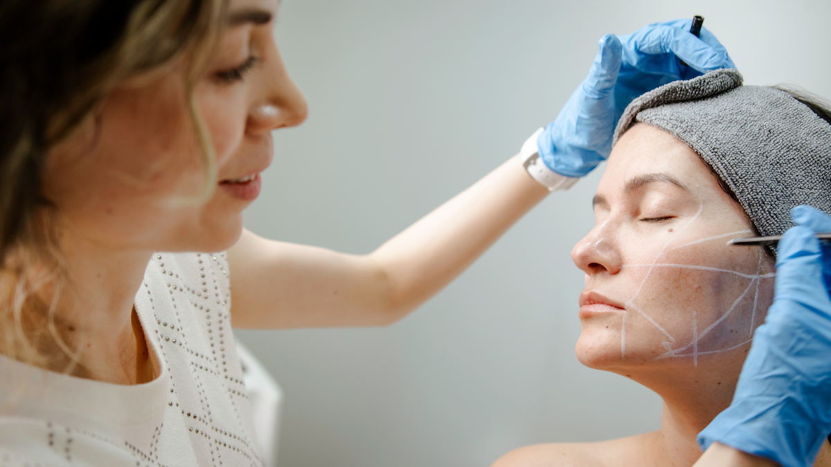 Médico especialista de Clínica Ohmio realizando marcación y valoración facial de paciente
