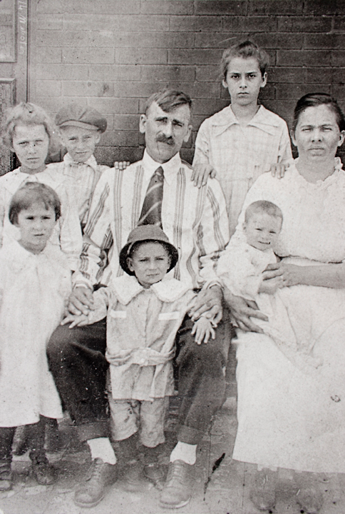 Original damaged vintage family photo showing fading and grain