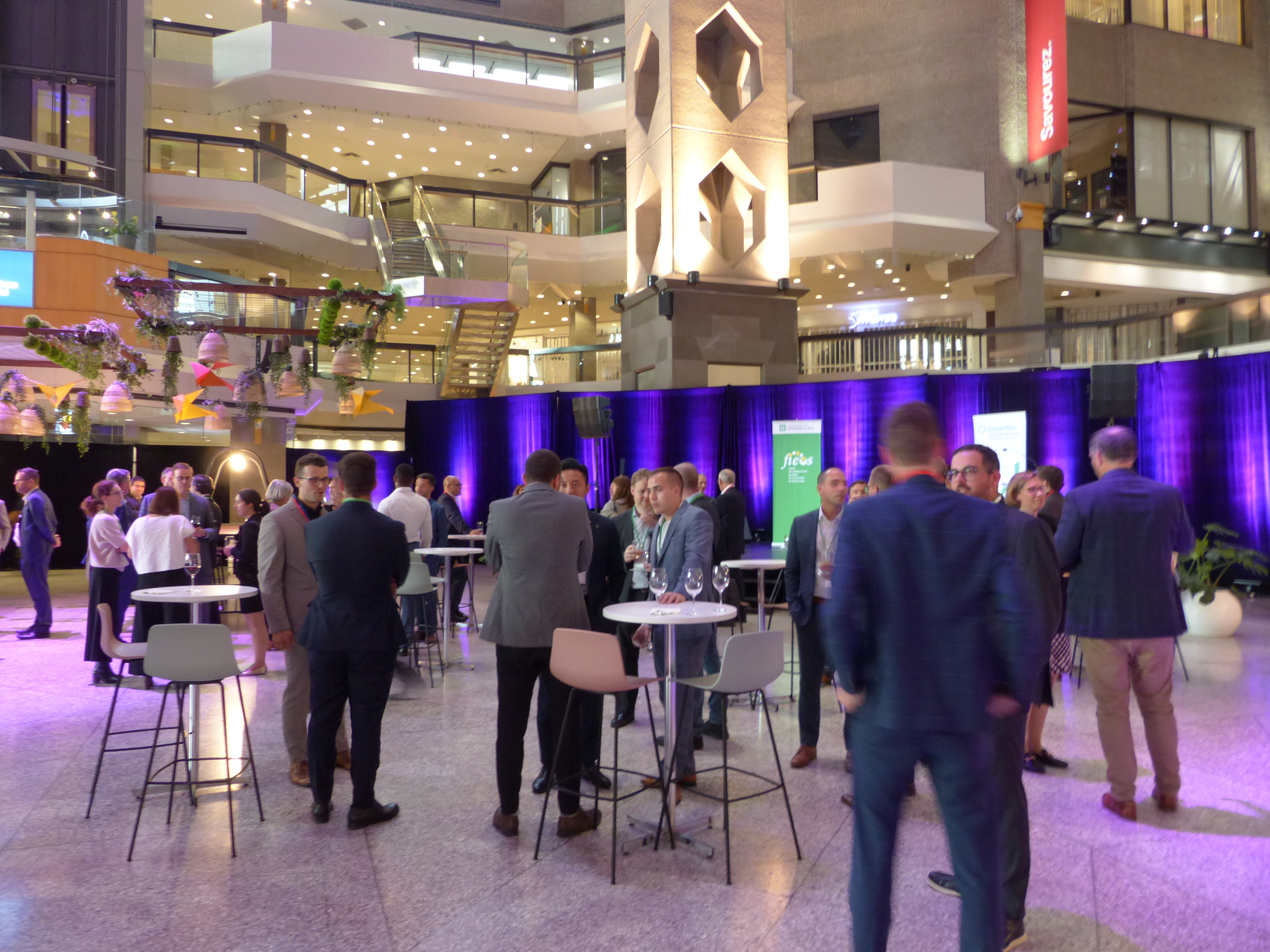 Événement de réseautage dans un atrium avec éclairage violet