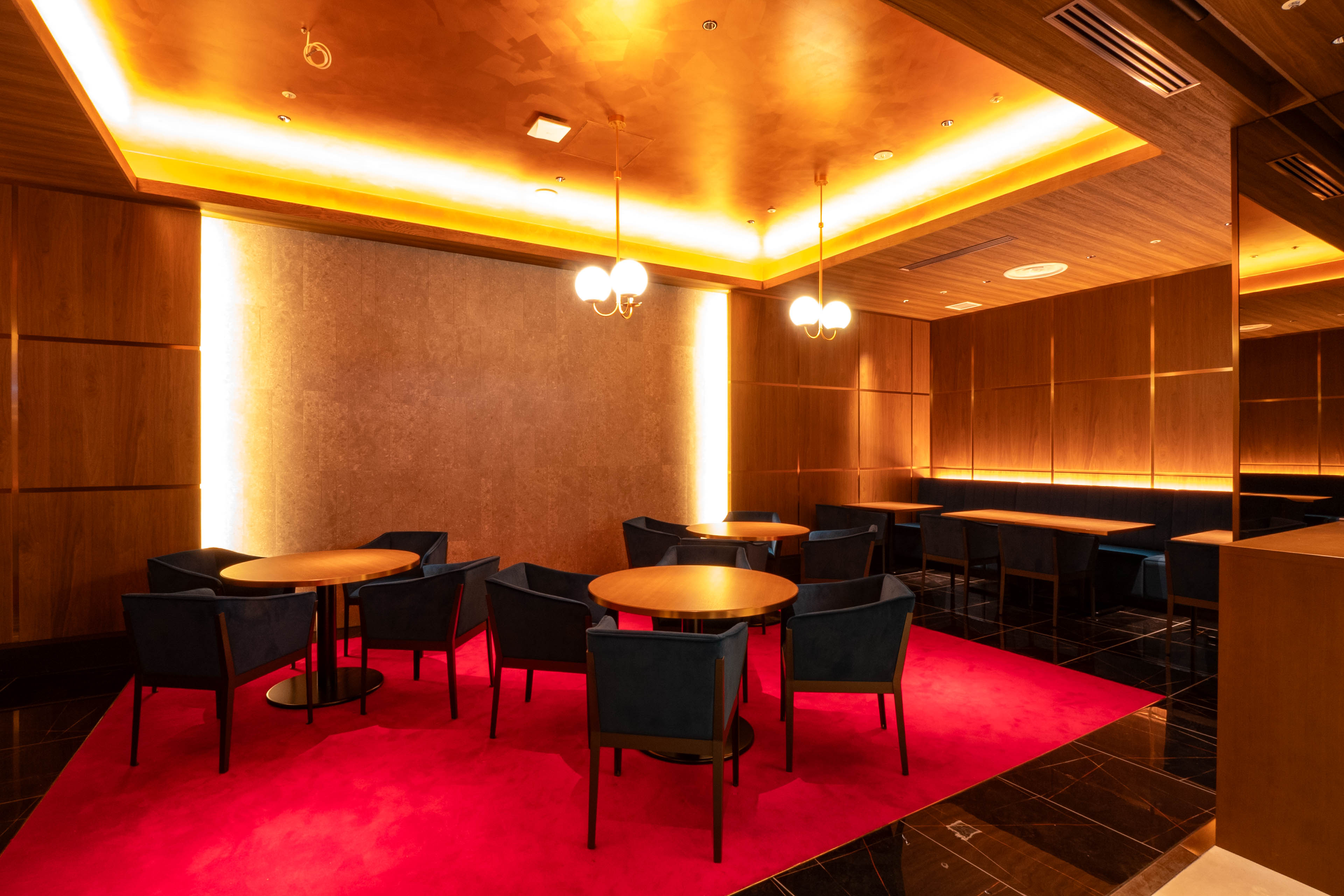 Luxurious lounge with red carpet and golden lighting