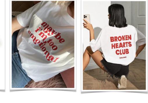 White graphic tee with bold red lettering across the front, shown beside a second graphic tee.