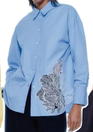 Blue button-front shirt with a large tonal floral appliqué near the hem.