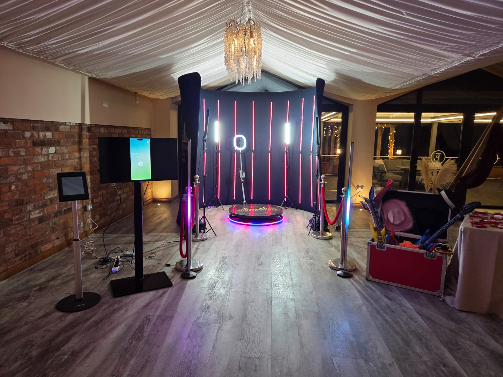 Full VIP 360 photo booth setup with LED backdrop and rope barriers