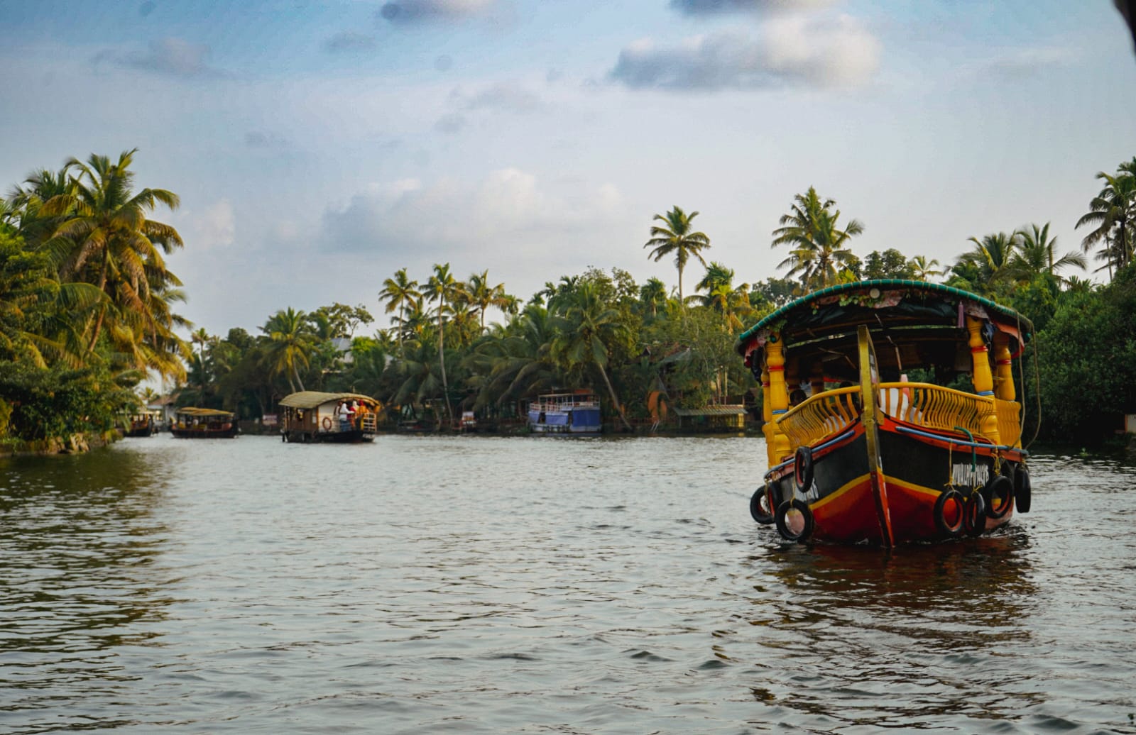 Colorful traditional boat cruising through Kerala backwaters