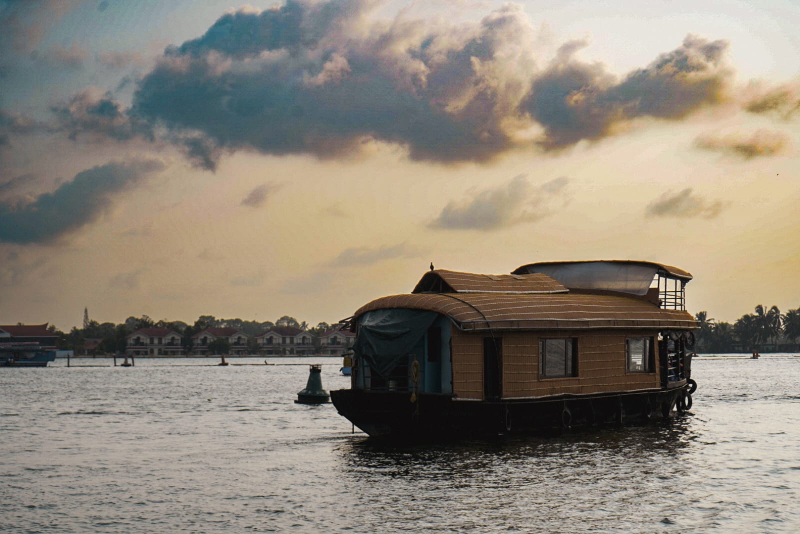 Kerala houseboat at golden hour sunset on backwaters