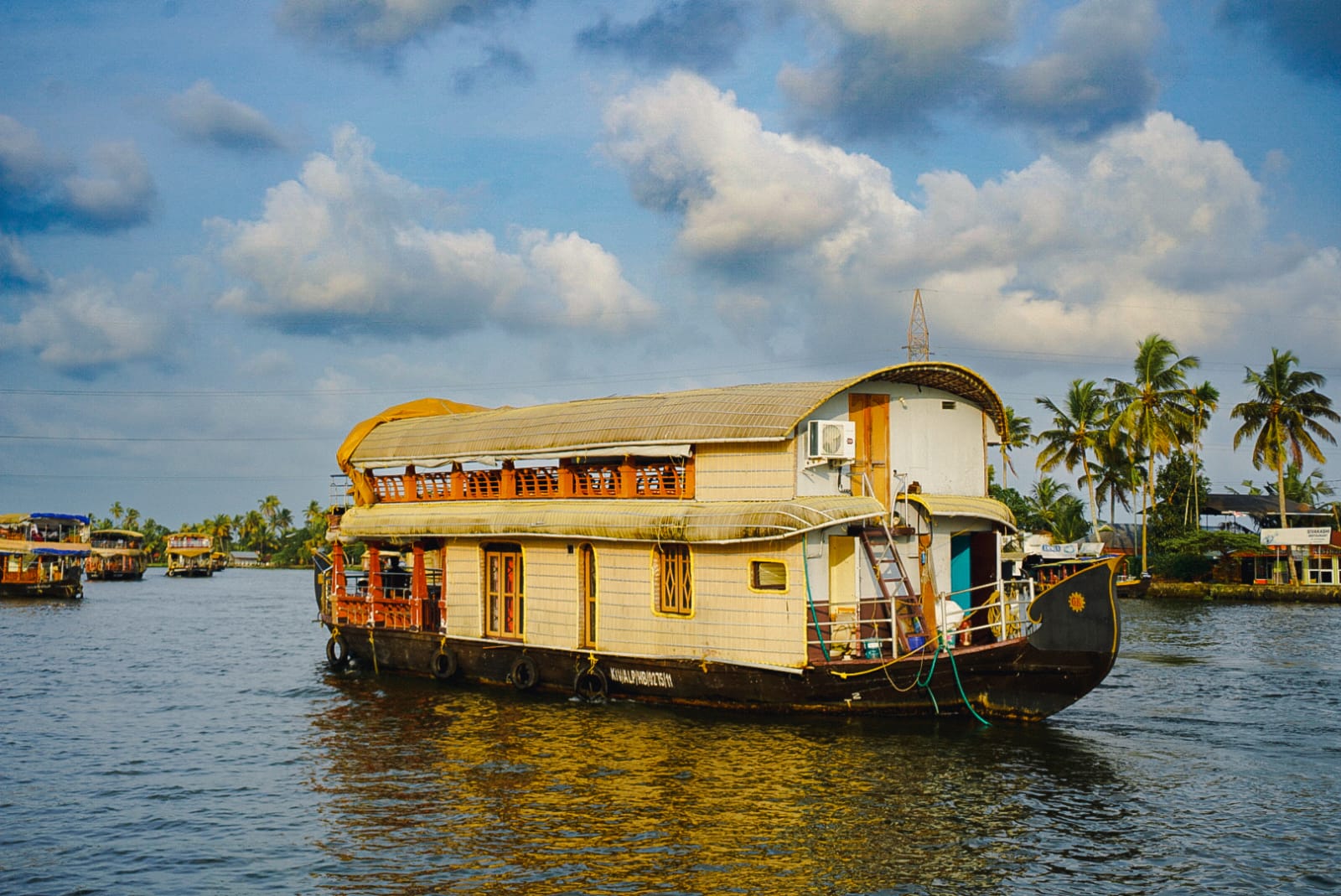 Large Kerala houseboat with orange trim on backwaters