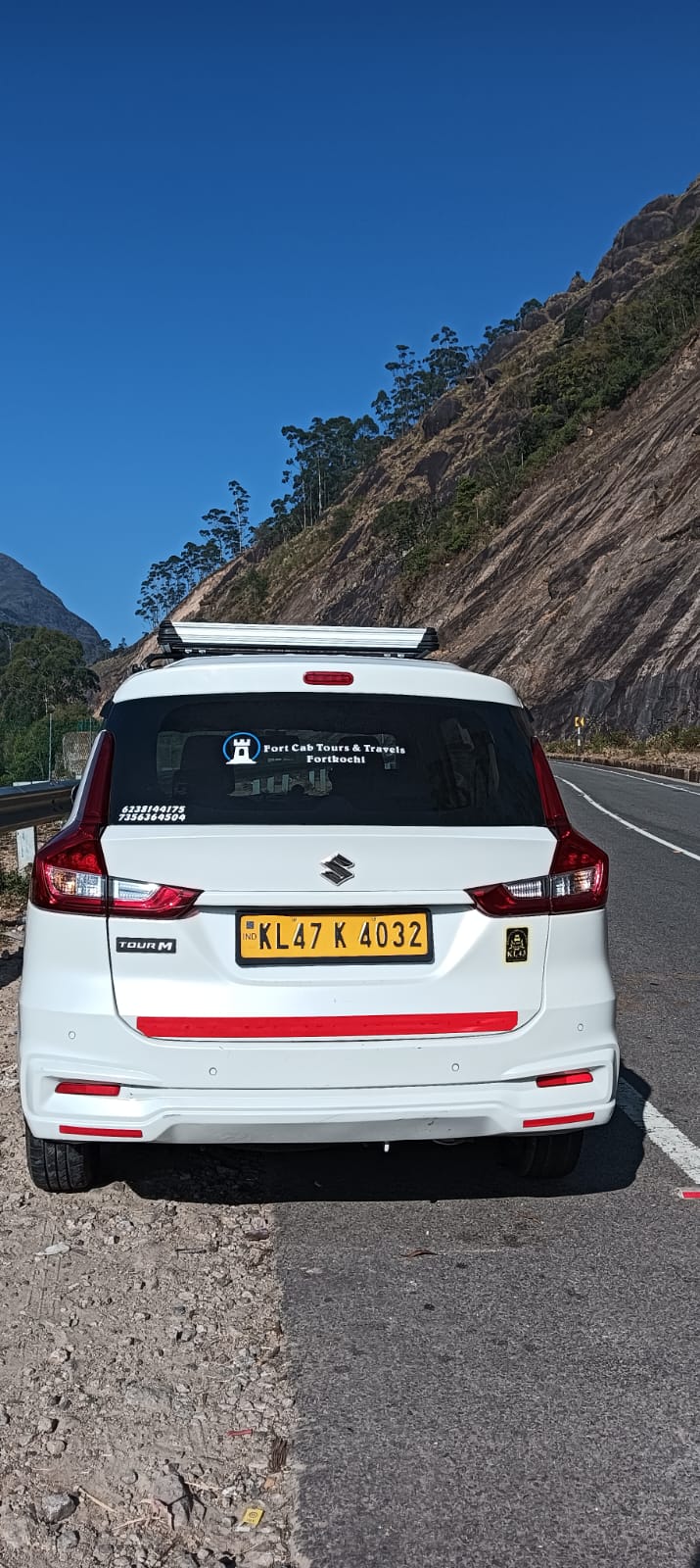 Fort Cab Tours branded Ertiga on scenic mountain road