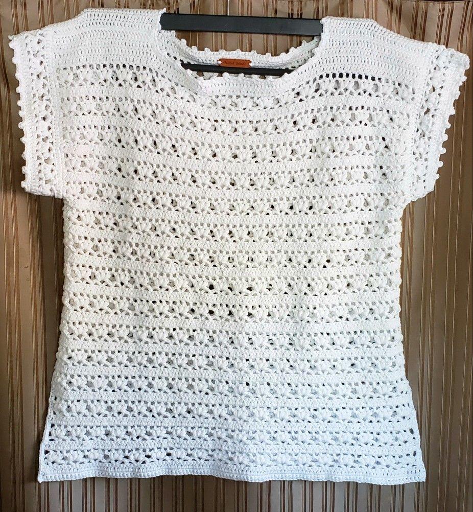 Ivory short-sleeve openwork crochet tee displayed on a hanger.